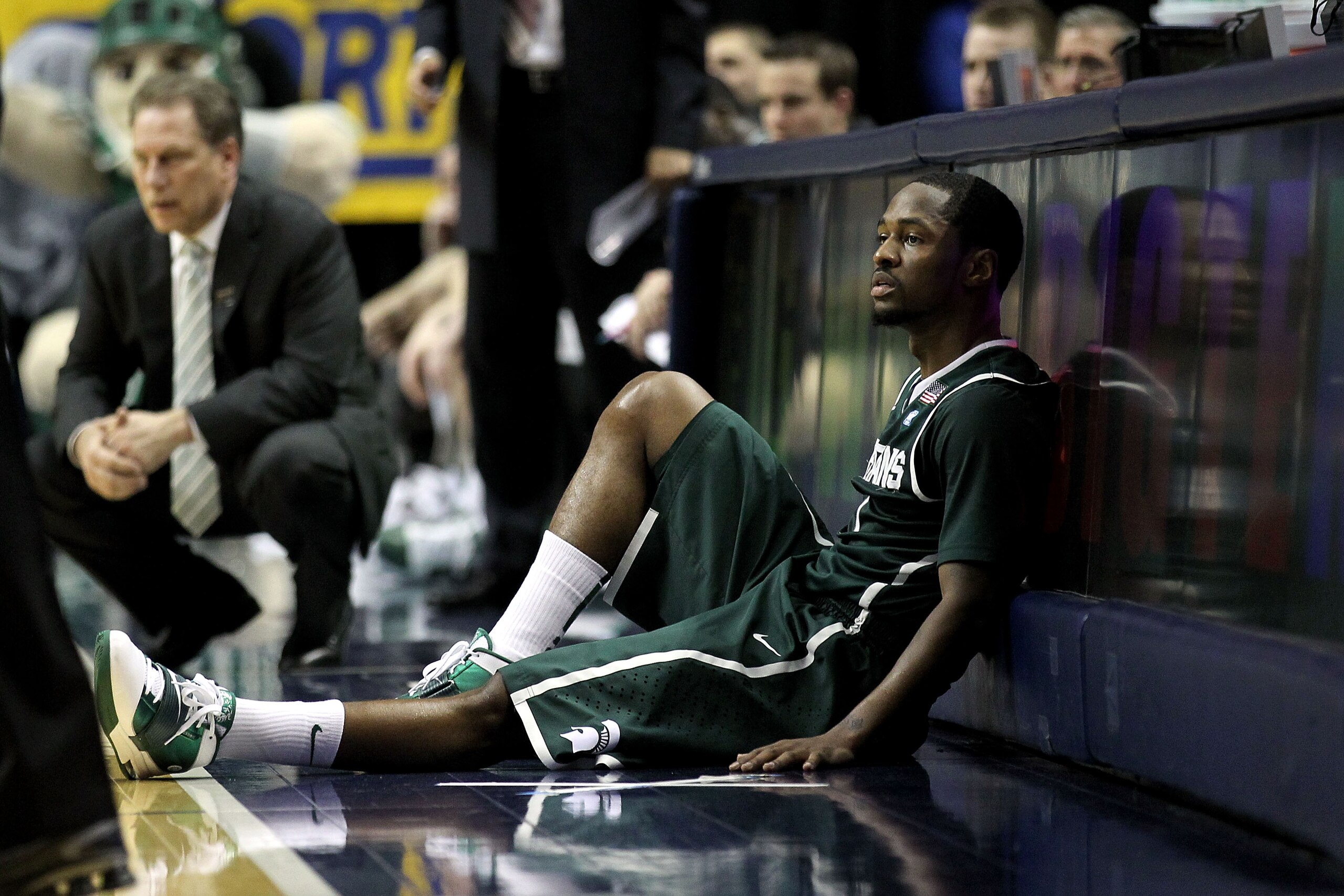 INDIANAPOLIS, IN - MARCH 12:  Kalin Lucas #1 of the Michigan State Spartans sits next to the scorer's table against the Penn State Nittany Lions during the semifinals of the 2011 Big Ten Men's Basketball Tournament at Conseco Fieldhouse on March 12, 2011