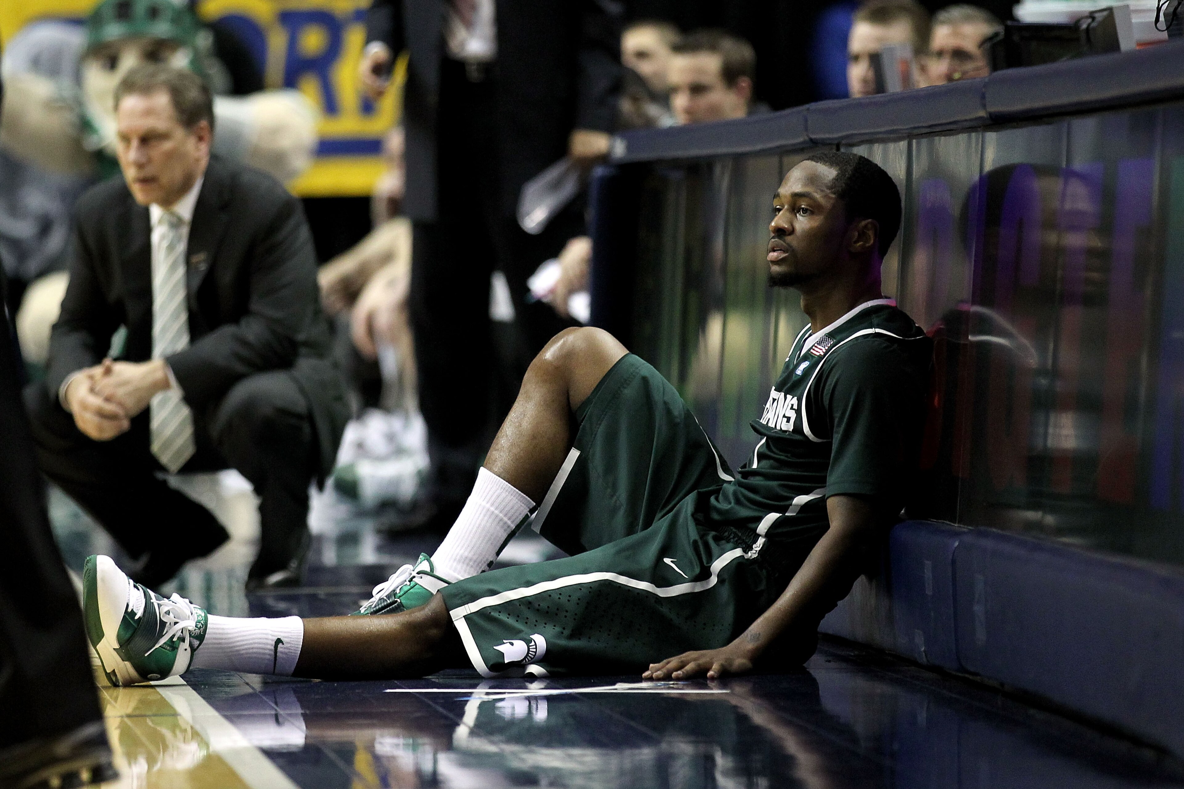 INDIANAPOLIS, IN - MARCH 12:  Kalin Lucas #1 of the Michigan State Spartans sits next to the scorer's table against the Penn State Nittany Lions during the semifinals of the 2011 Big Ten Men's Basketball Tournament at Conseco Fieldhouse on March 12, 2011