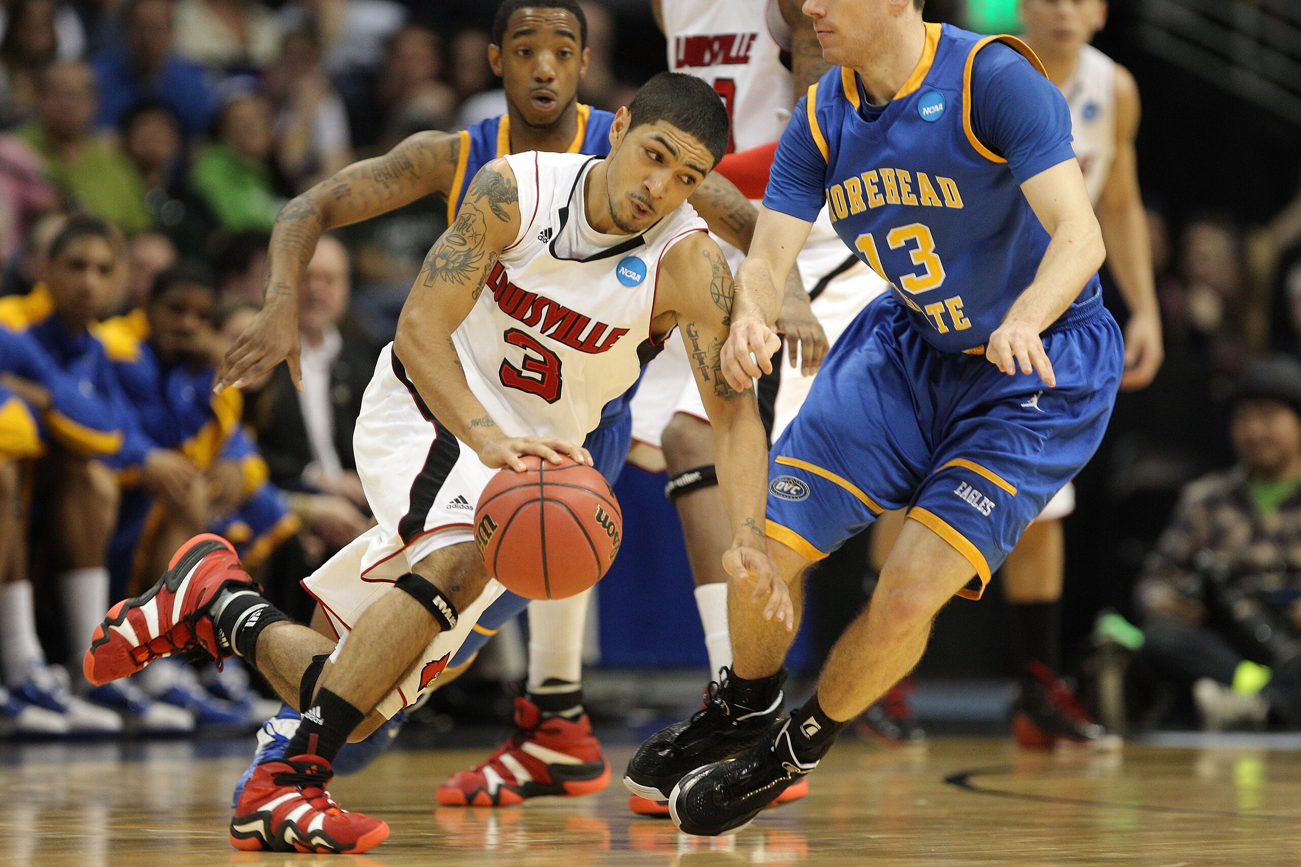 DENVER, CO - MARCH 17:  Peyton Siva #3 of the Louisville Cardinals handles the ball against Ty Proffitt #13 of the Morehead State Eagles and Lamont Austin #10 during the second round of the 2011 NCAA men's basketball tournament at Pepsi Center on March 17