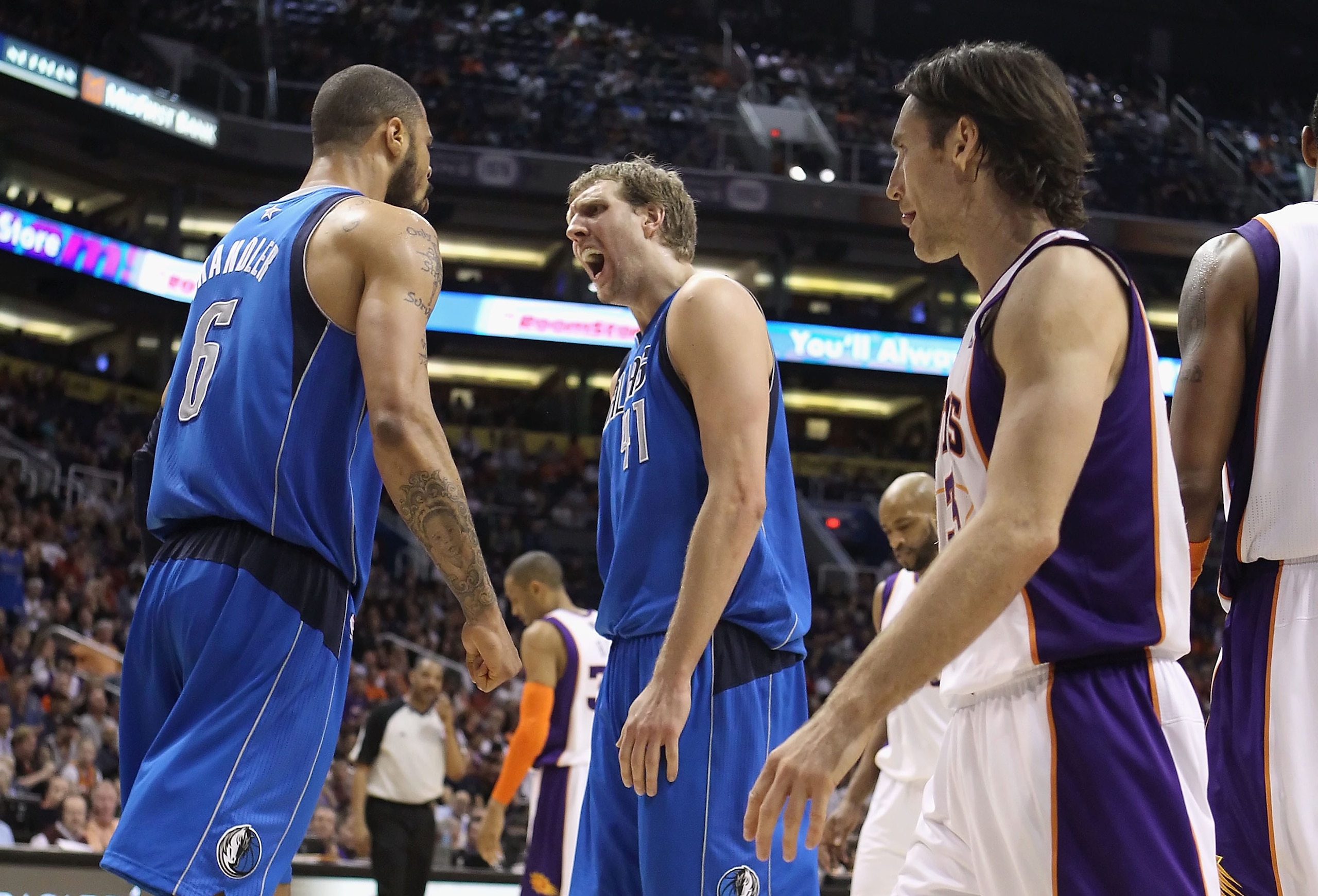 PHOENIX, AZ - FEBRUARY 17:  Dirk Nowitzki #41 of the Dallas Mavericks reacts to teammate Tyson Chandler #6 after Chandler scored and drew a foul against the Phoenix Suns during the NBA game at US Airways Center on February 17, 2011 in Phoenix, Arizona.  T