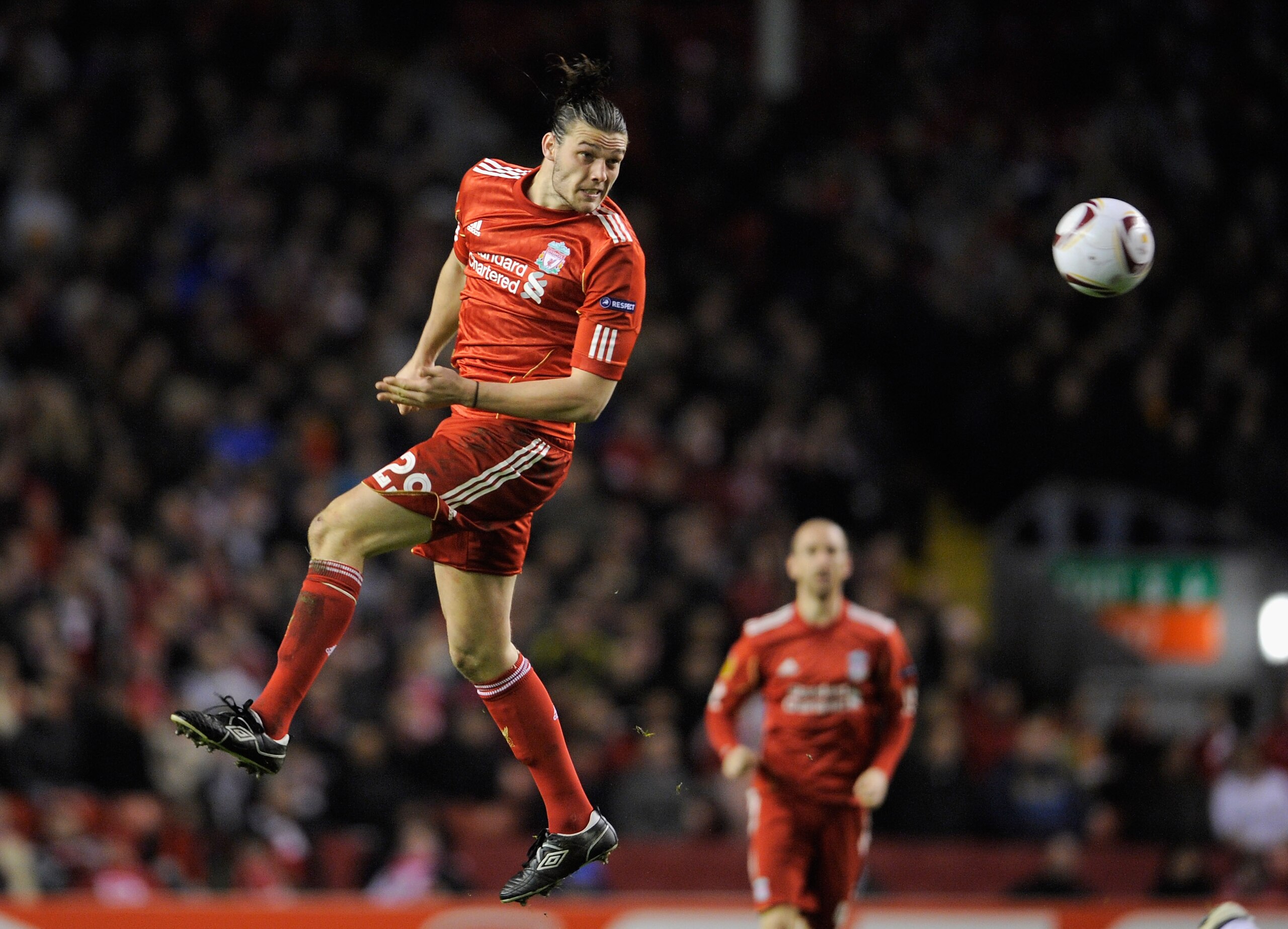 LIVERPOOL, ENGLAND - MARCH 17:  Andy Carroll of Liverpool heads the ball during the UEFA Europa League Round of 16 second leg match between Liverpool and SC Braga at Anfield on March 17, 2011 in Liverpool, England.  (Photo by Michael Regan/Getty Images)