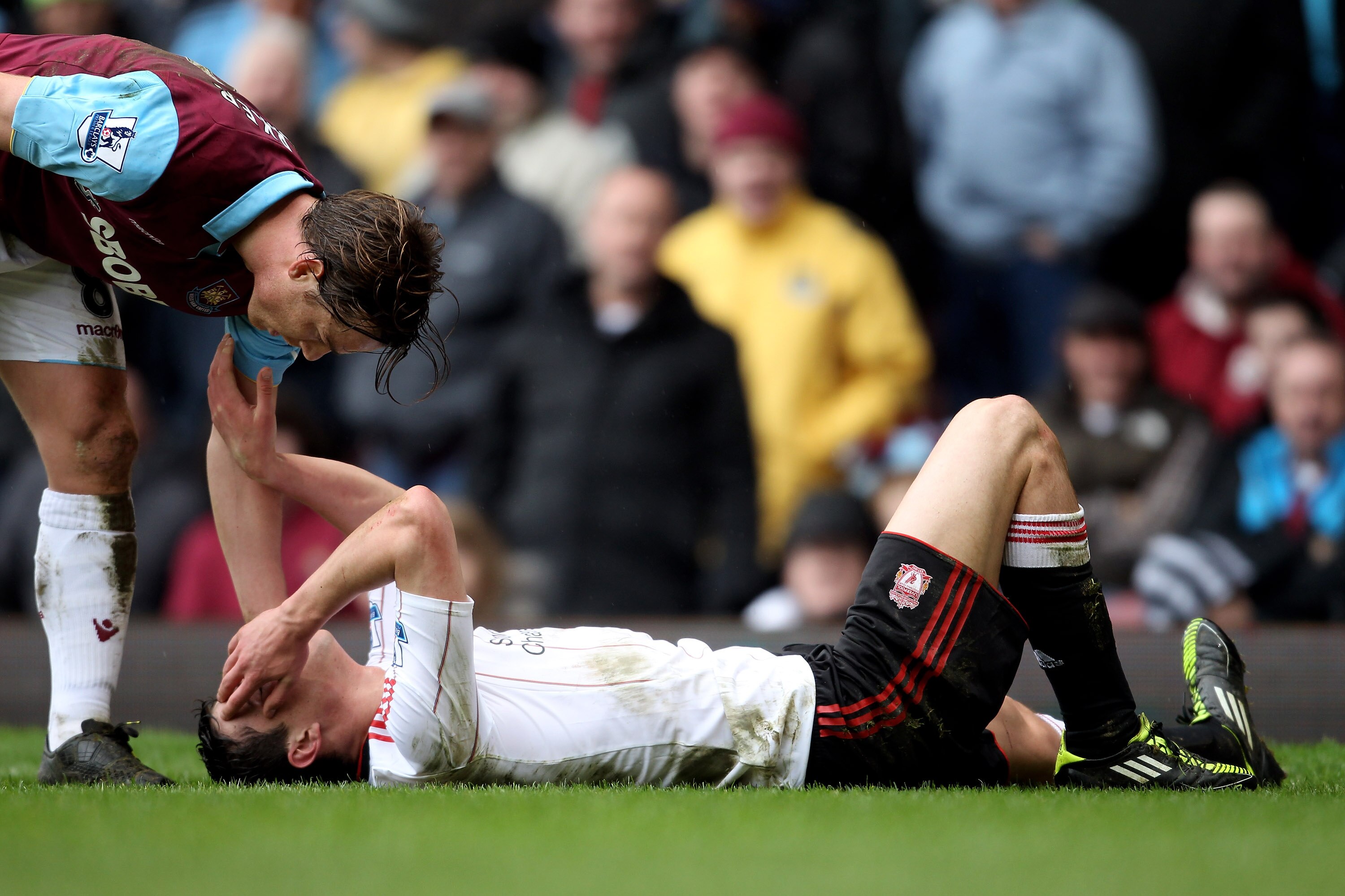 LONDON, ENGLAND - FEBRUARY 27:  Martin Kelly of Liverpool lies on the pitch injured during the Barclays Premier League match between West Ham United and Liverpool at the Boleyn Ground on February 27, 2011 in London, England.  (Photo by Scott Heavey/Getty