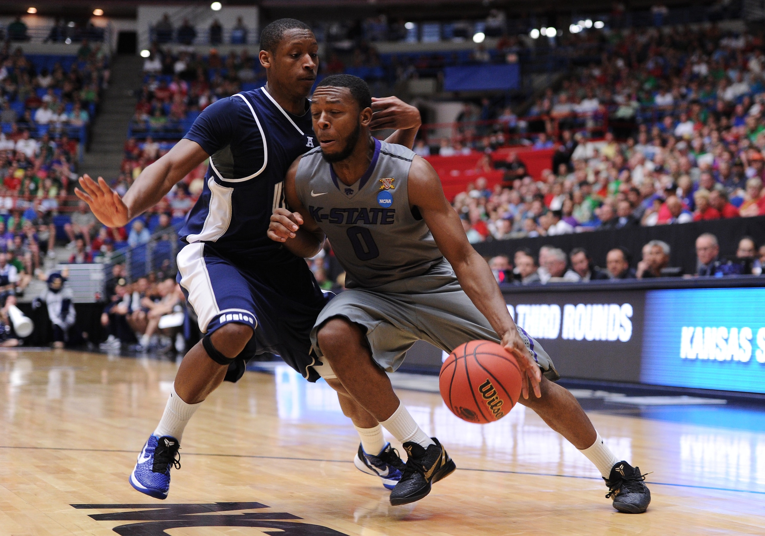 TUCSON, AZ - MARCH 17:  Jacob Pullen #0 of the Kansas State Wildcats drives against Pooh Williams #5 of the Utah State Aggies during the second round of the 2011 NCAA men's basketball tournament at McKale Center on March 17, 2011 in Tucson, Arizona.  (Pho