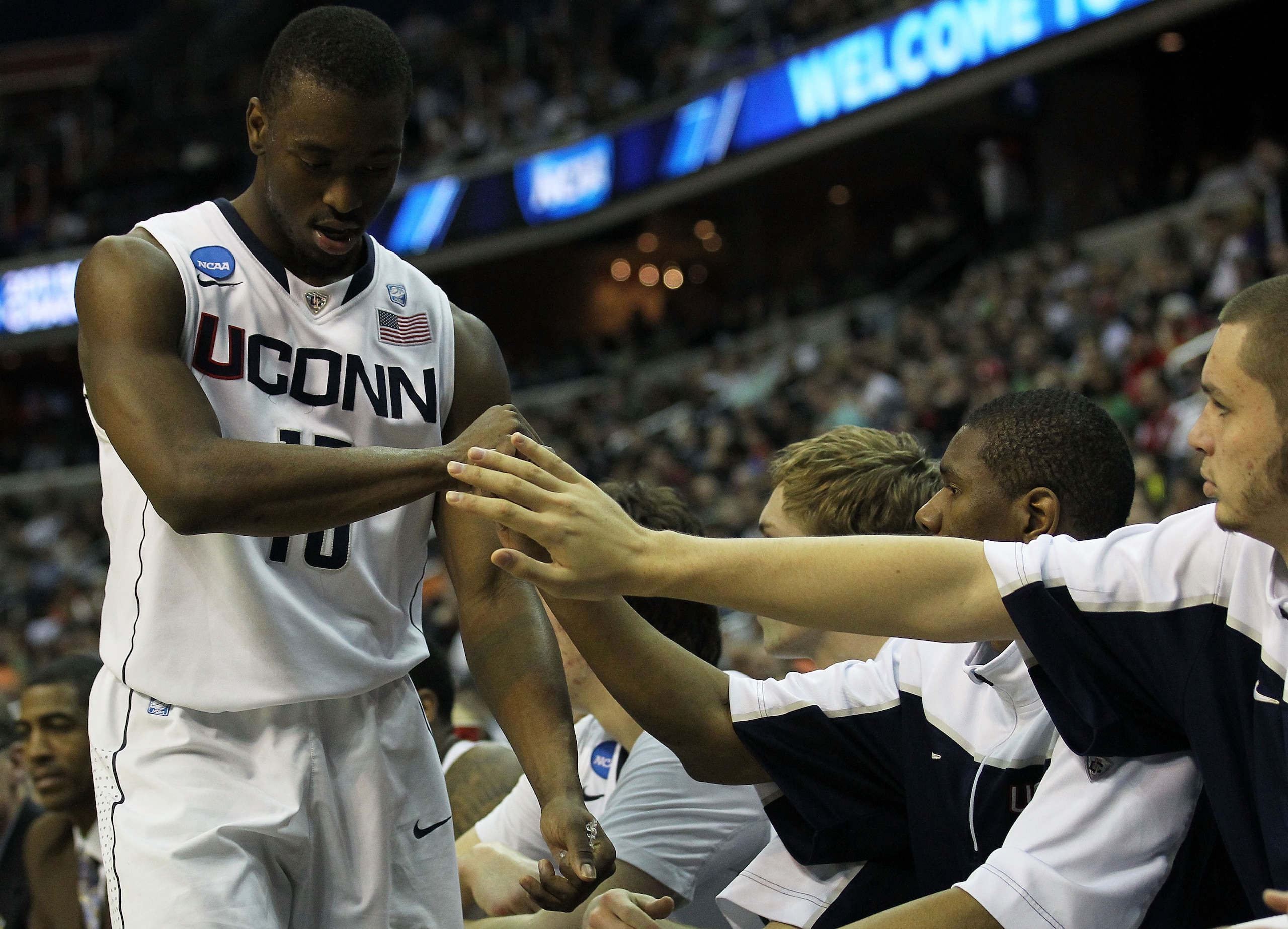 WASHINGTON - MARCH 17:  Kemba Walker #15 of the Connecticut Huskies is congratulate by teammates during their game against the Bucknell Bison during the second round of the 2011 NCAA men's basketball tournament at the Verizon Center on March 17, 2011 in W