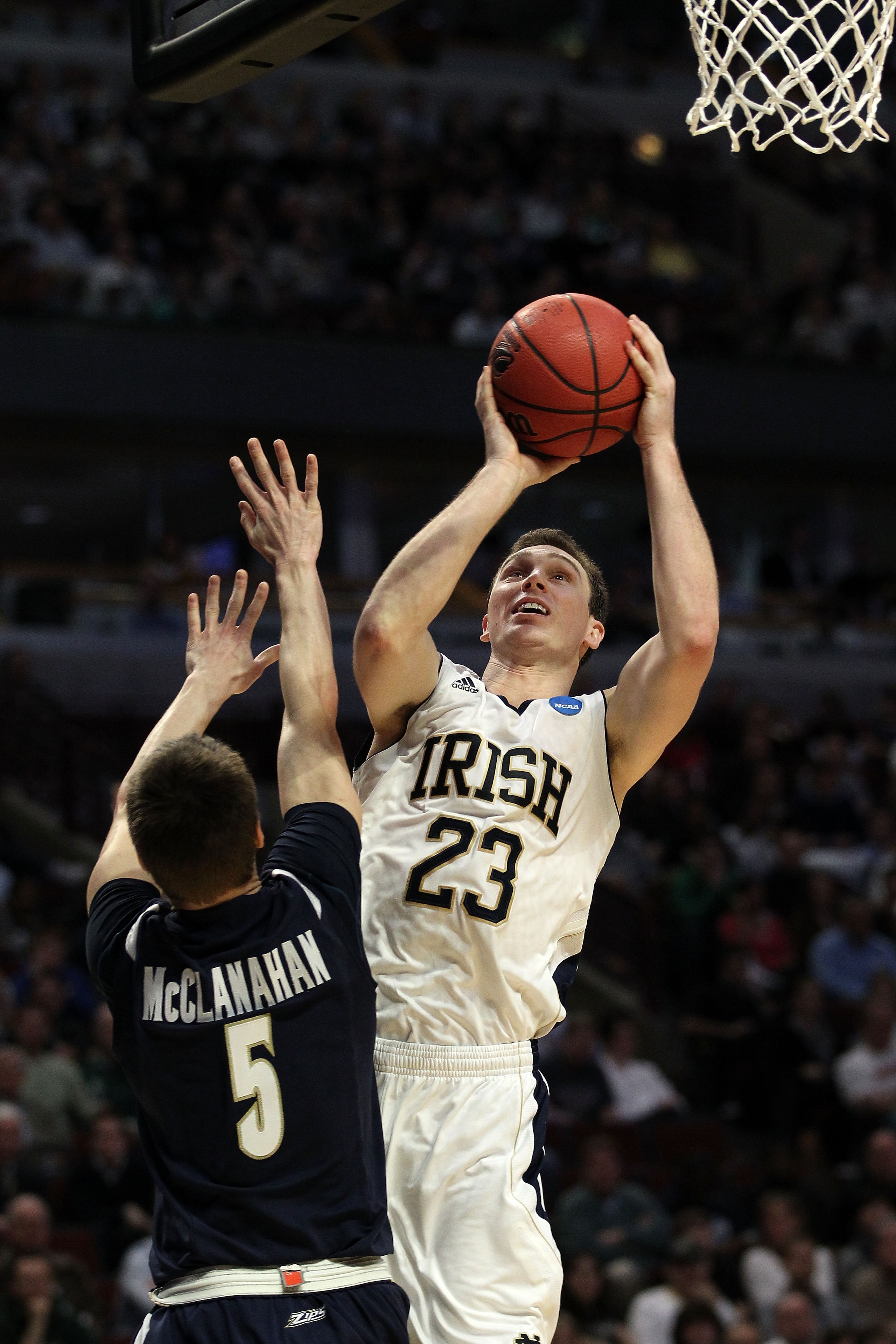 CHICAGO, IL - MARCH 18: Ben Hansbrough #23 of the Notre Dame Fighting Irish shoots against Brett McClanahan #5 of the Akron Zips in the second half during the second round of the 2011 NCAA men's basketball tournament at the United Center on March 18, 2011