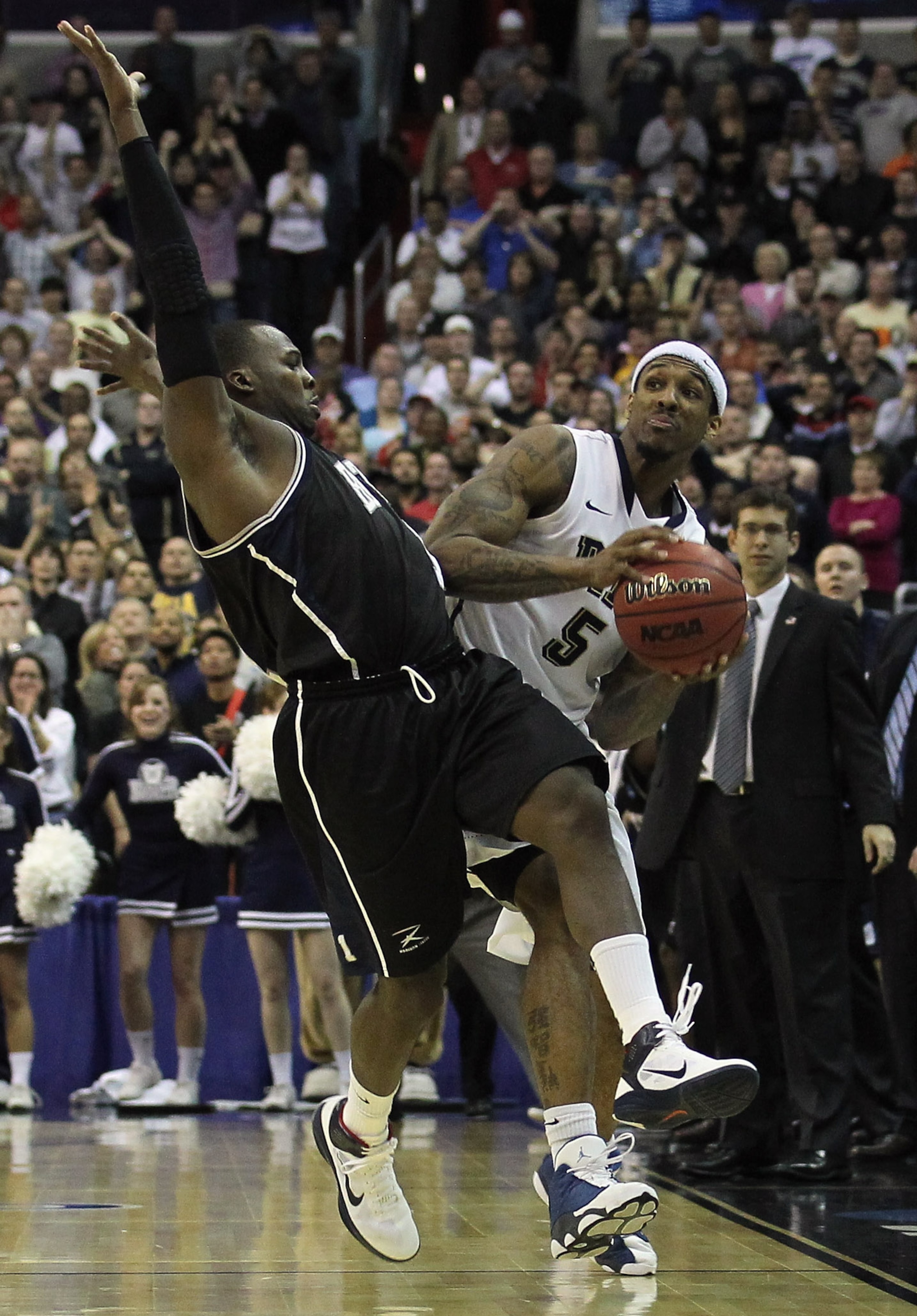 WASHINGTON - MARCH 19: Shelvin Mack #1 of Butler University fouls Gilbert Brown #5 of Pittsburgh with just over one second to play during the third round of the 2011 NCAA men's basketball tournament at Verizon Center on March 19, 2011 in Washington, DC. B