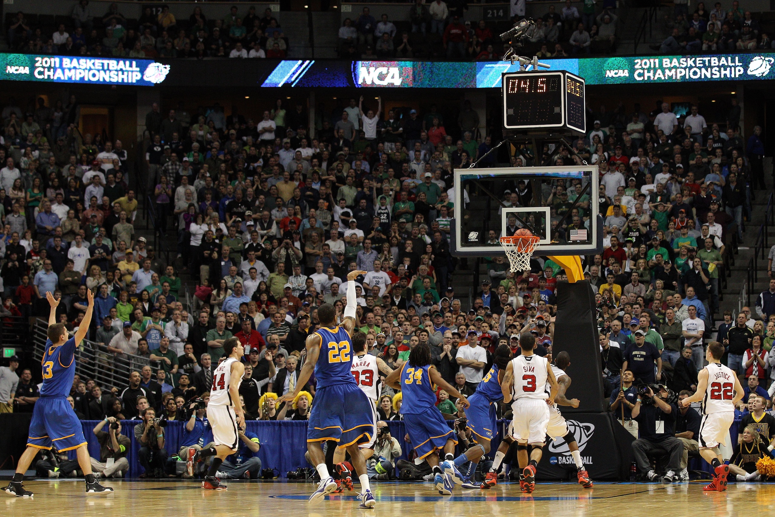 DENVER, CO - MARCH 17:  Demonte Harper #22 of the Morehead State Eagles shoots the game winning three point shot with 5.5 seconds left on the clock against the Louisville Cardinals during the second round of the 2011 NCAA men's basketball tournament at Pe