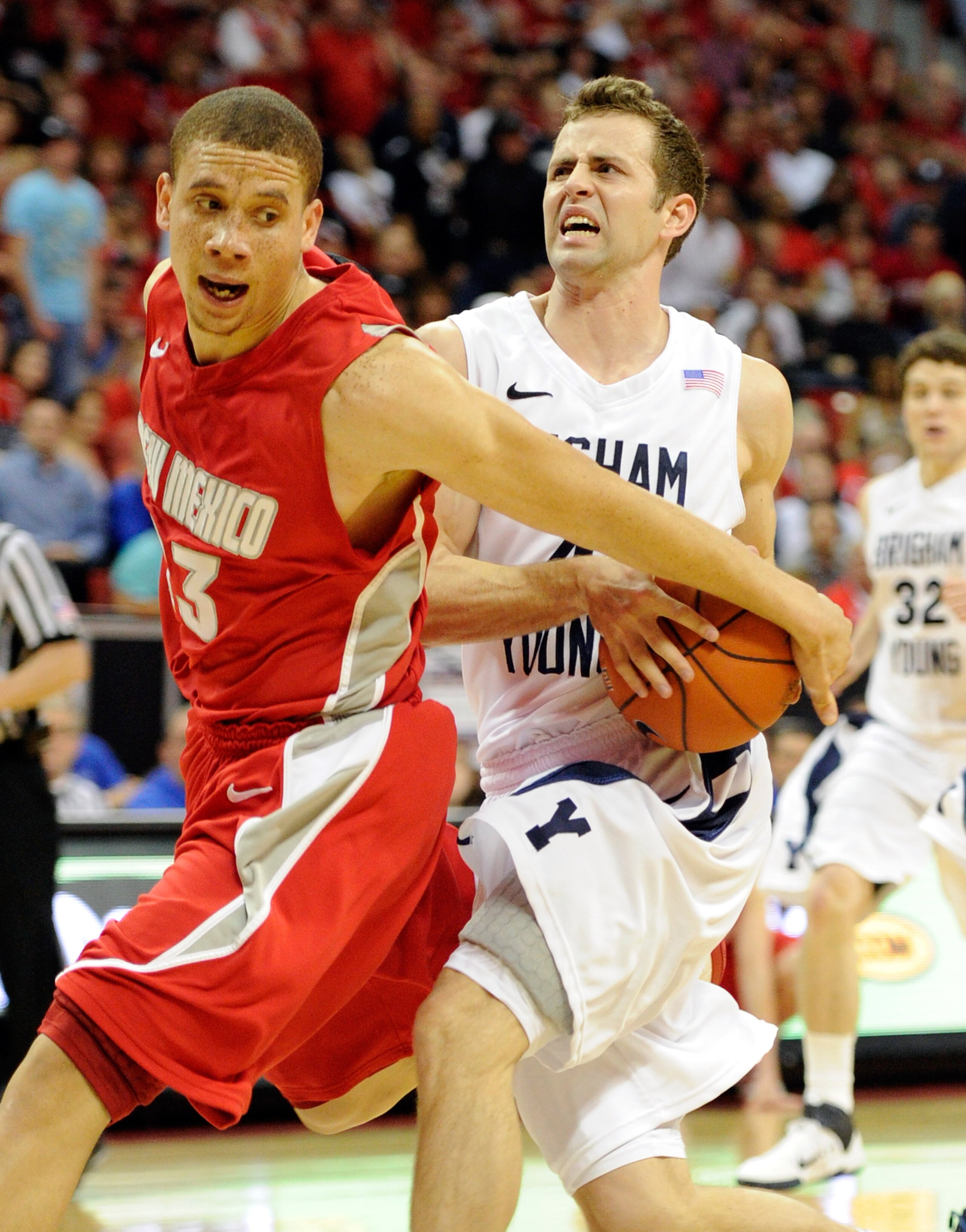 LAS VEGAS, NV - MARCH 11: Jackson Emery #4 of the Brigham Young University Cougars is fouled by Phillip McDonald #23 of the New Mexico Lobos during a semifinal game of the Conoco Mountain West Conference Basketball tournament at the Thomas & Mack Center LAS VEGAS, NV - MARCH 11: Jackson Emery #4 of the Brigham Young University Cougars is fouled by Phillip McDonald #23 of the New Mexico Lobos during a semifinal game of the Conoco Mountain West Conference Basketball tournament at the Thomas & Mack Center