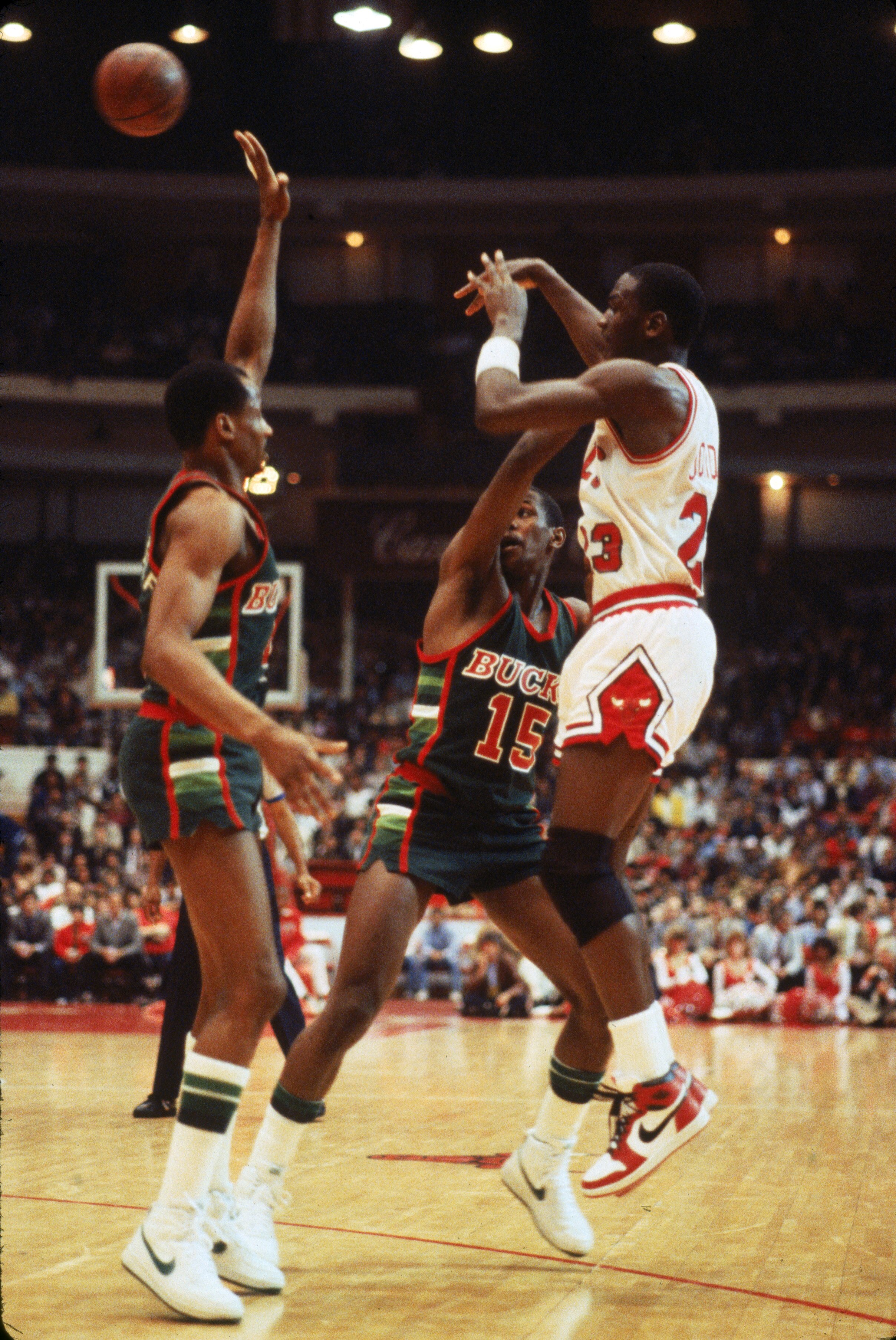 CHICAGO - APRIL 1985:  Michael Jordan #23 of the Chicago Bulls passes the ball against the Milwaukee Bucks during an Eastern Conference First Round Playoff game April 1985 game at the Chicago Stadium in Chicago, Illinois. The Bucks won the series 3-1. (Ph