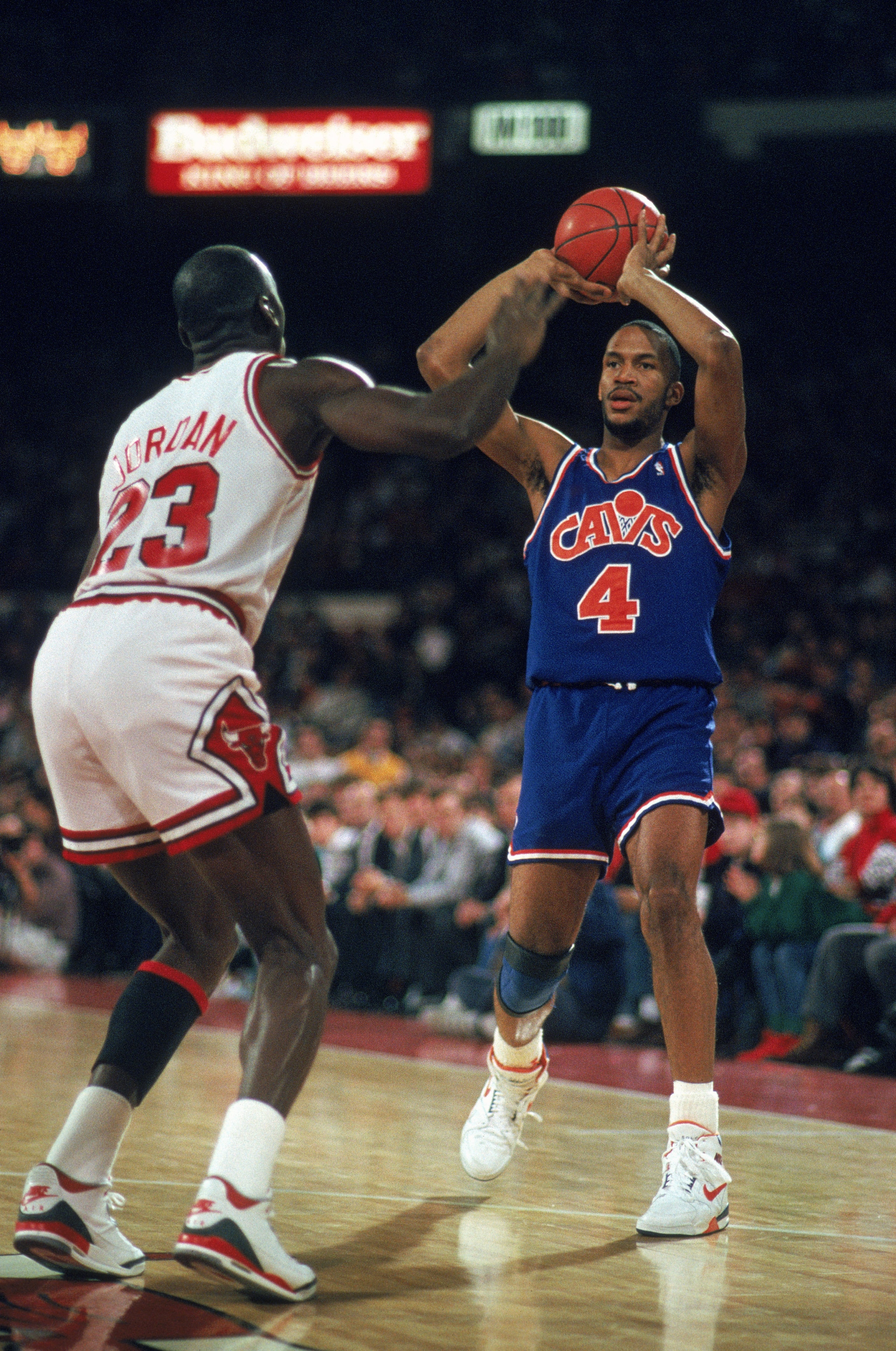 1989:  Ron Harper of the Cleveland Cavaliers holds the ball as Michael Jordan plays defense in Chicago, Illinois during the 1988-1989 NBA season. Mandatory Credit:  Jonathan Daniel/Getty Images