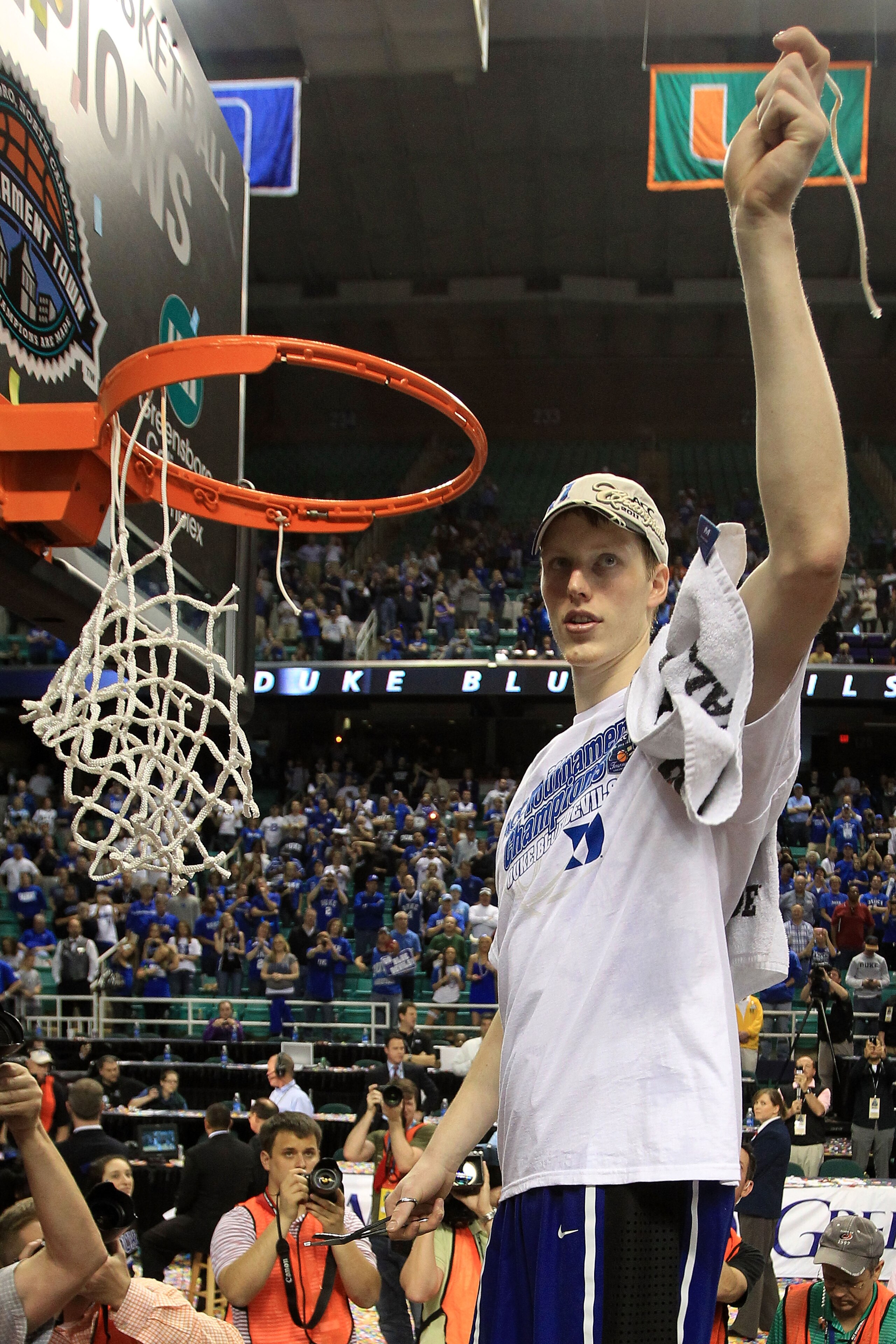 GREENSBORO, NC - MARCH 13: Kyle Singler #12 of the Duke Blue Devils cuts down the net after defeating the North Carolina Tar Heels 75-58 in the championship game of the 2011 ACC men's basketball tournament at the Greensboro Coliseum on March 13, 2011 in GREENSBORO, NC - MARCH 13: Kyle Singler #12 of the Duke Blue Devils cuts down the net after defeating the North Carolina Tar Heels 75-58 in the championship game of the 2011 ACC men's basketball tournament at the Greensboro Coliseum on March 13, 2011 in