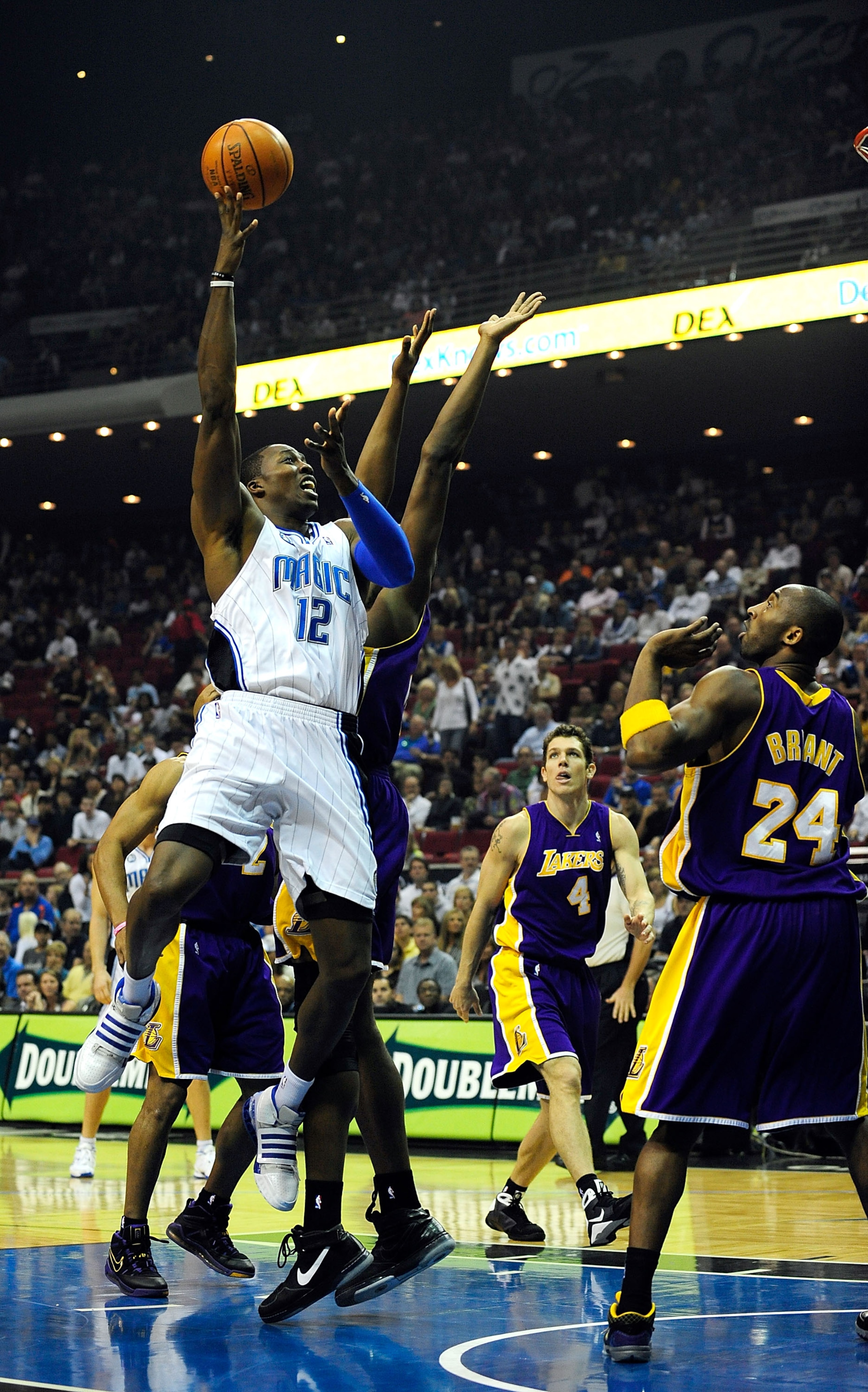 ORLANDO, FL - DECEMBER 20:  Dwight Howard #12 of the Orlando Magic attempts a shot over Kobe Bryant #24 of the Los Angeles Lakers on December 20, 2008 at Amway Arena in Orlando, Florida.  NOTE TO USER: User expressly acknowledges and agrees that, by downl