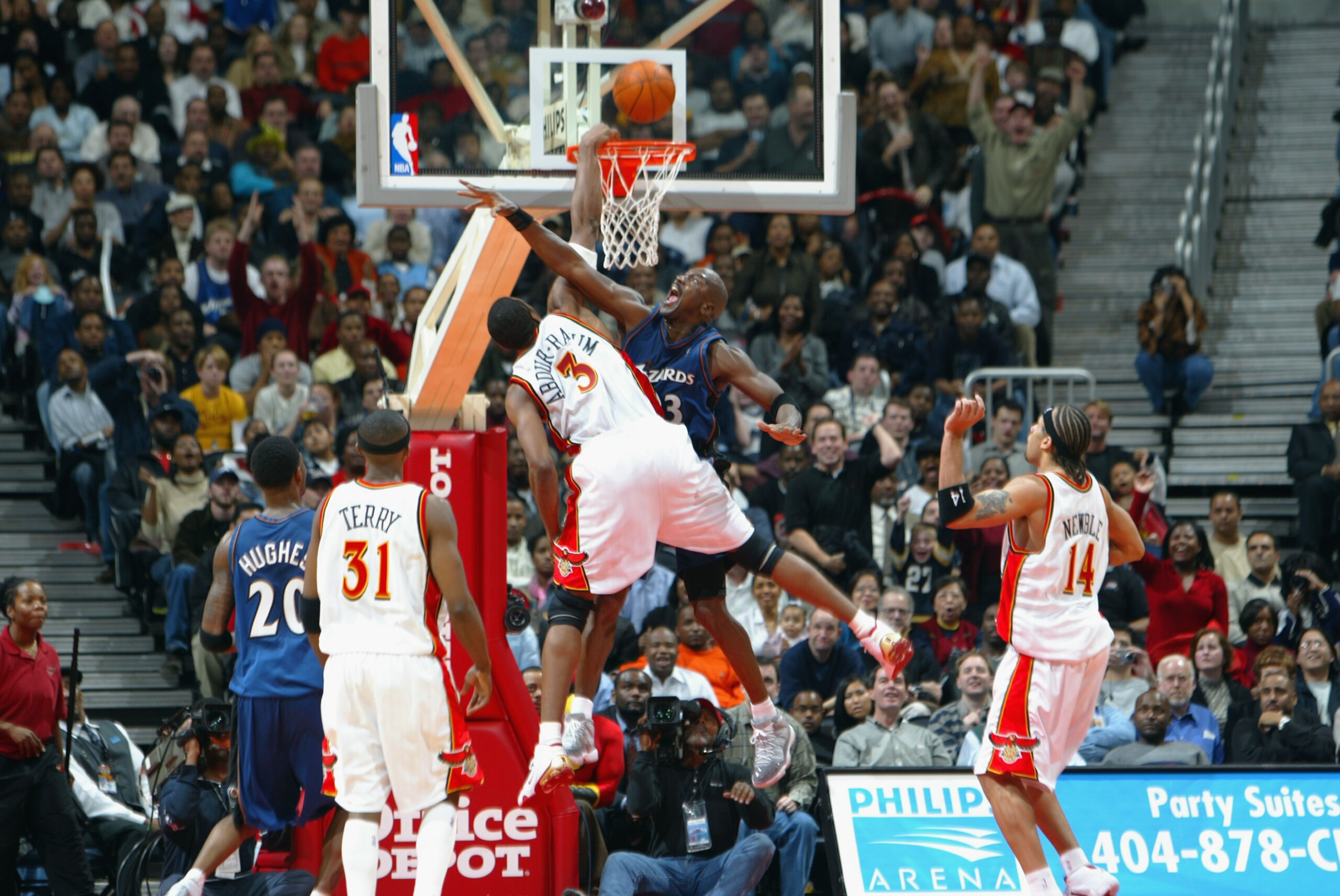 ATLANTA - DECEMBER 17:  Guard Michael Jordan #23 of the Washington Wizards fouls forward Shareef Abdur-Rahim #3 of the Atlanta Hawks as he tries to dunk during the second half of the game on December 17, 2002 at Phillips Arena in Atlanta, Georgia.  The Wi