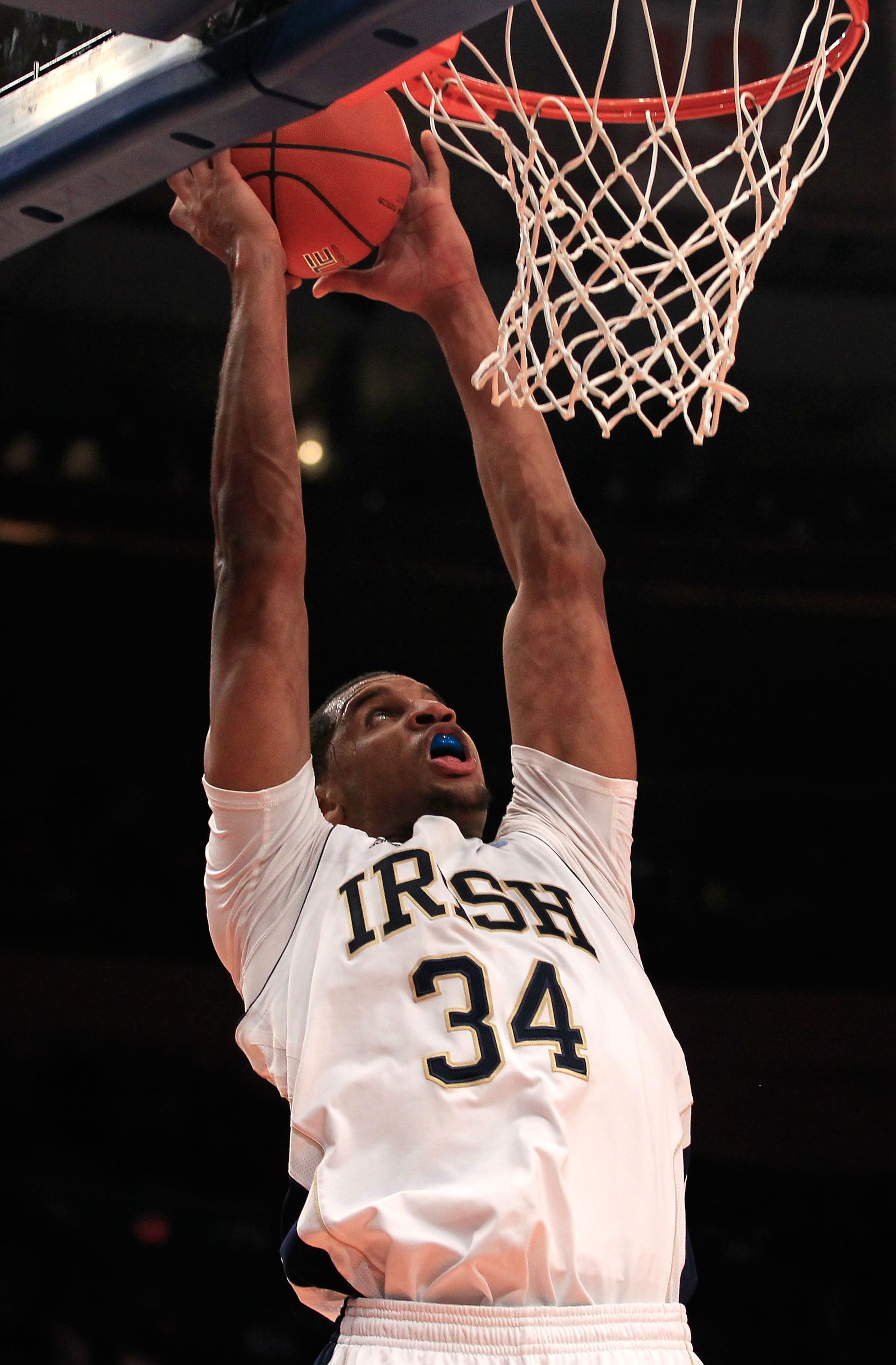 NEW YORK, NY - MARCH 10: Carleton Scott #34 of the Notre Dame Fighting Irish goes up for a dunk against the Cincinnati Bearcats during the quarterfinals of the 2011 Big East Men's Basketball Tournament presented by American Eagle Outfitters  at Madison Sq