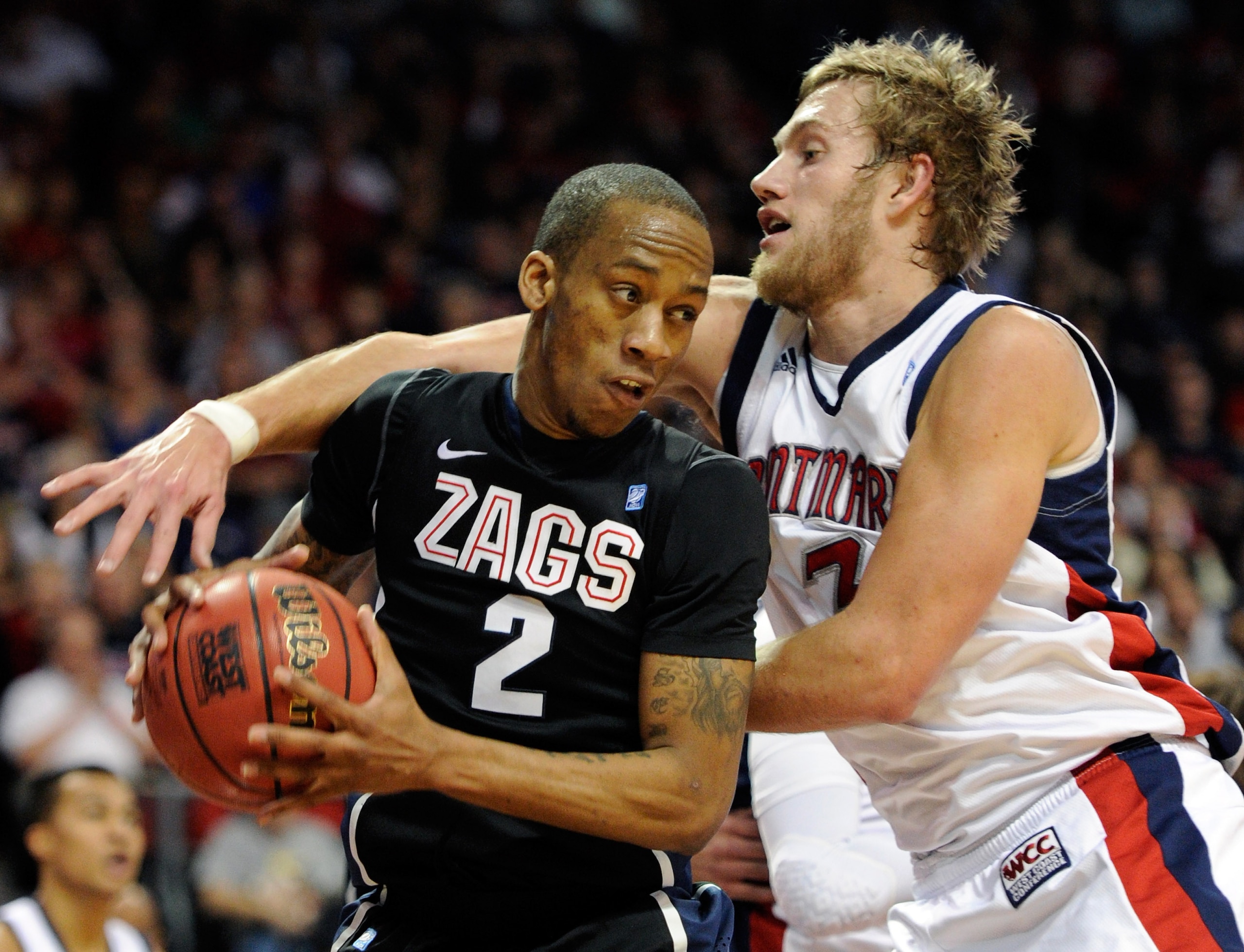 LAS VEGAS, NV - MARCH 07:  Marquise Carter #2 of the Gonzaga Bulldogs grabs a rebound in front of Mitchell Young #3 of the Saint Mary's Gaels during the championship game of the Zappos.com West Coast Conference Basketball tournament at the Orleans Arena M