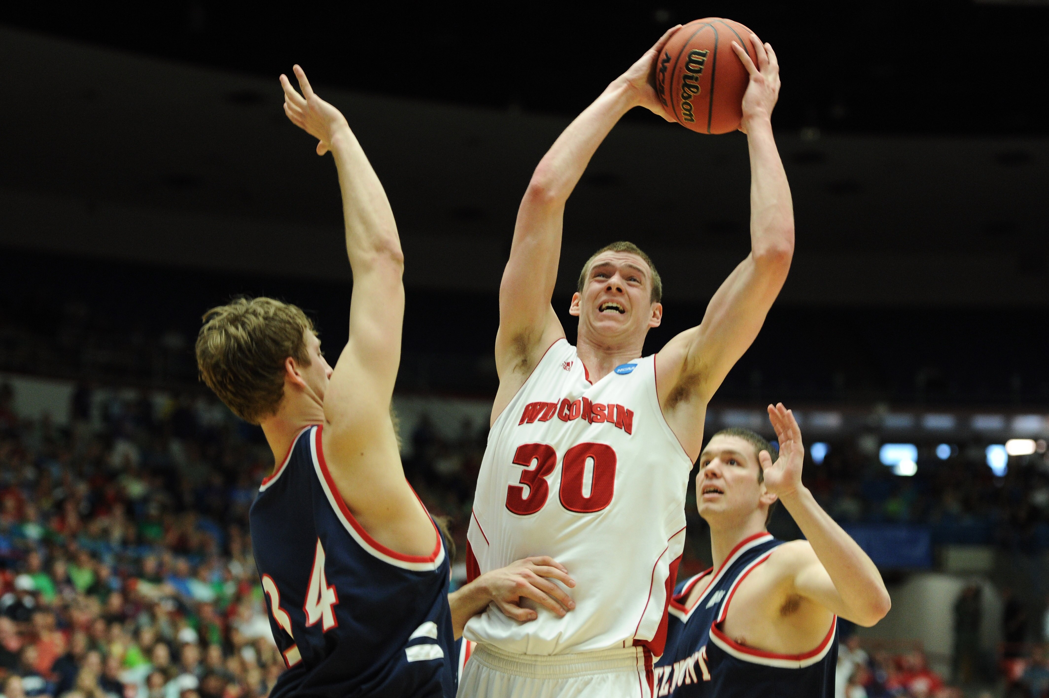 TUCSON, AZ - MARCH 17:  Jon Leuer #30 of the Wisconsin Badgers goes up against Mick Hedgepeth #34 and Trevor Noack #30 of the Belmont Bruins during the second round of the 2011 NCAA men's basketball tournament at McKale Center on March 17, 2011 in Tucson,