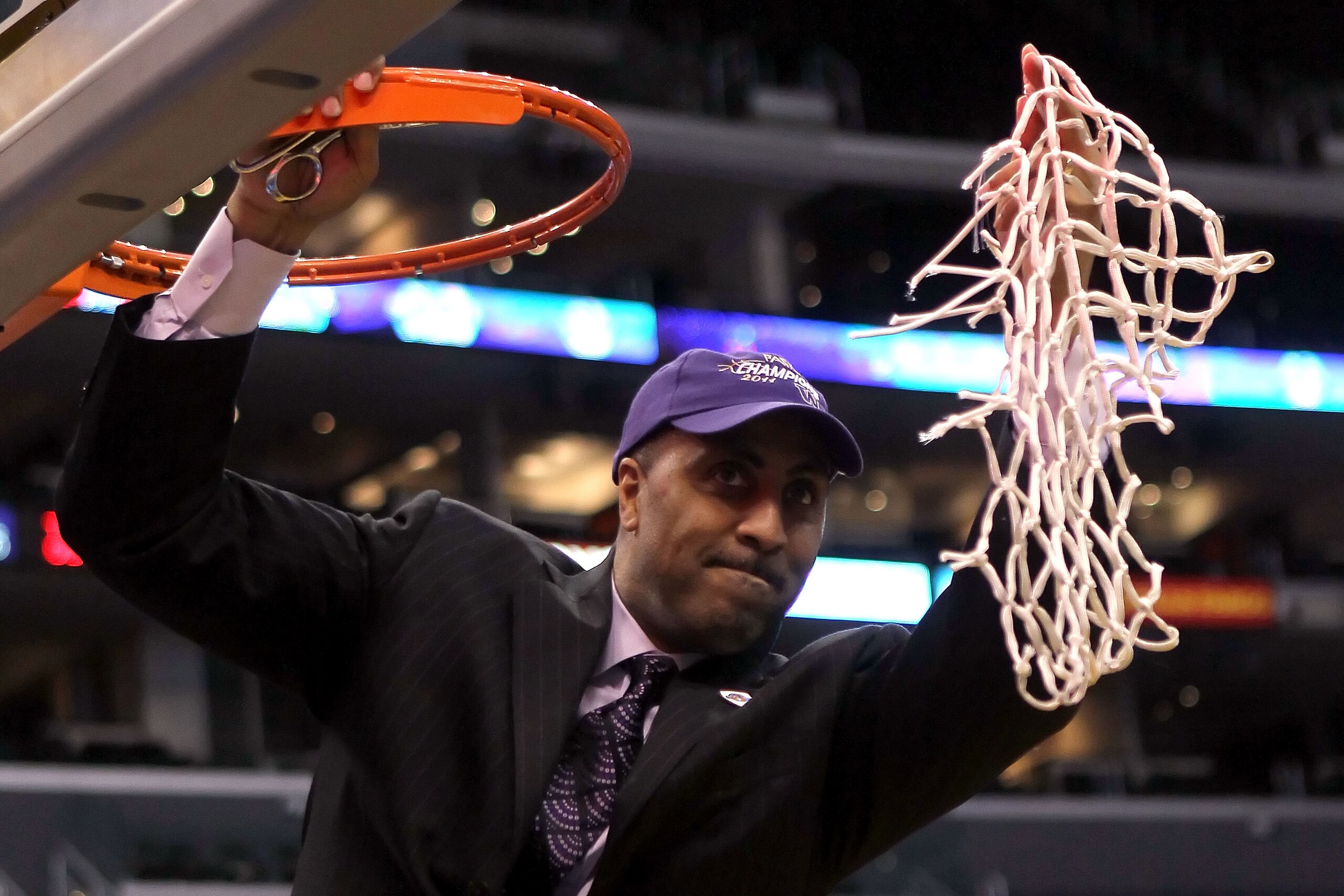 LOS ANGELES, CA - MARCH 12:  Head coach Lorenzo Romar of the Washington Huskies celebrates by cutting down the net after the Huskies defeated the Arizona Wildcats 77-75 in the championship game of the 2011 Pacific Life Pac-10 Men's Basketball Tournament a