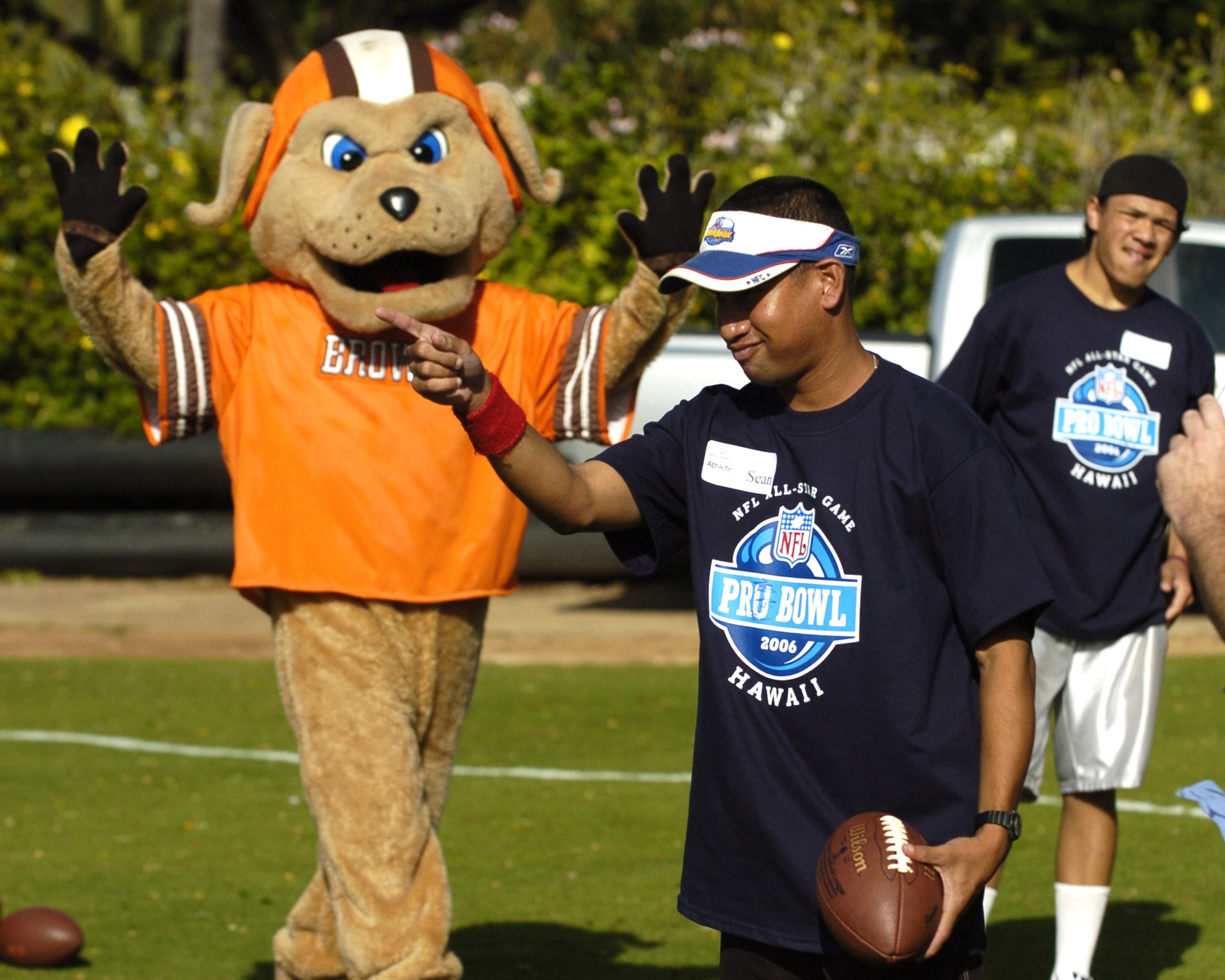 A young punter lines up a kick as the Cleveland Browns mascot watches during the Special Olympics  February 8, 2006 in Honolulu, Hawaii.  (Photo by Al Messerschmidt/Getty Images)