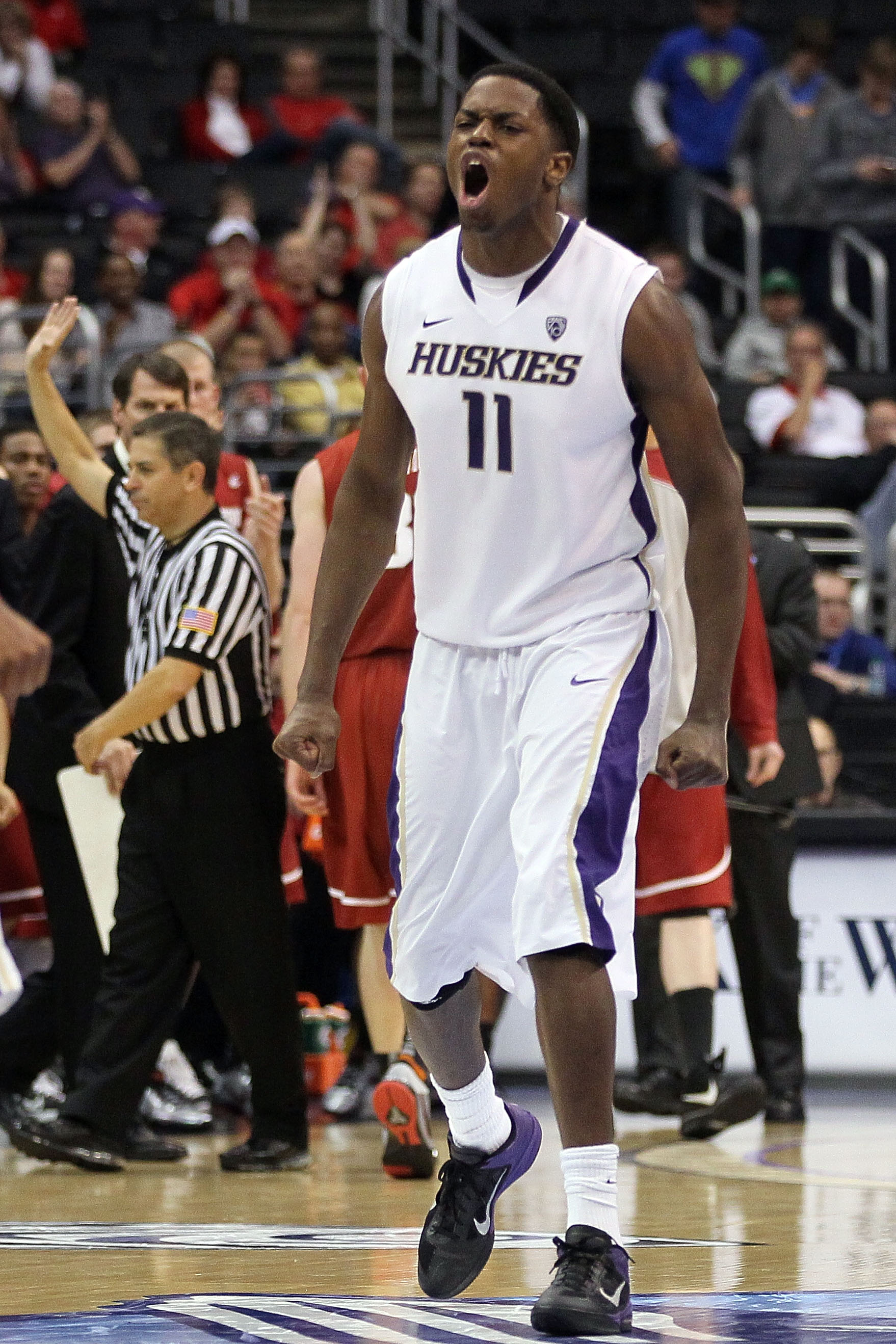 LOS ANGELES, CA - MARCH 10: Matthew Bryan-Amaning #11 of the Washington Huskies reacts in the second half while taking on the Washington State Cougars in the quarterfinals of the 2011 Pacific Life Pac-10 Men's Basketball Tournament at Staples Center on M