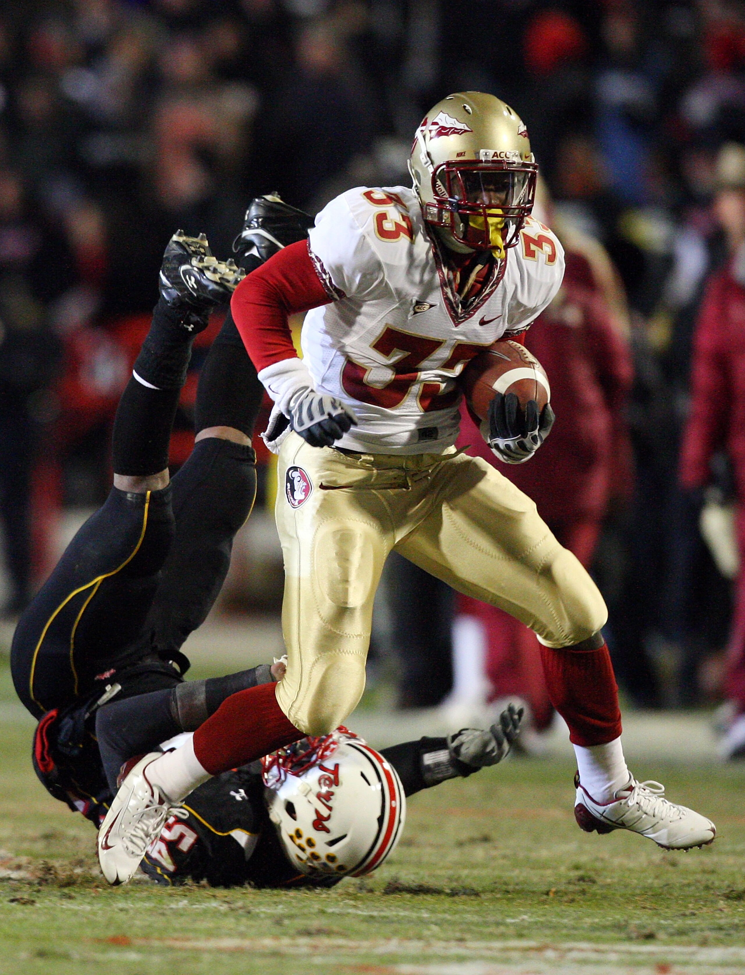COLLEGE PARK, MD - NOVEMBER 22:  Carlton Jones #33 of the Florida State Seminoles runs the ball past Adrian Moten #54 of the Maryland Terrapins on November 22, 2008 at Byrd Stadium in College Park, Maryland.  (Photo by Jim McIsaac/Getty Images)