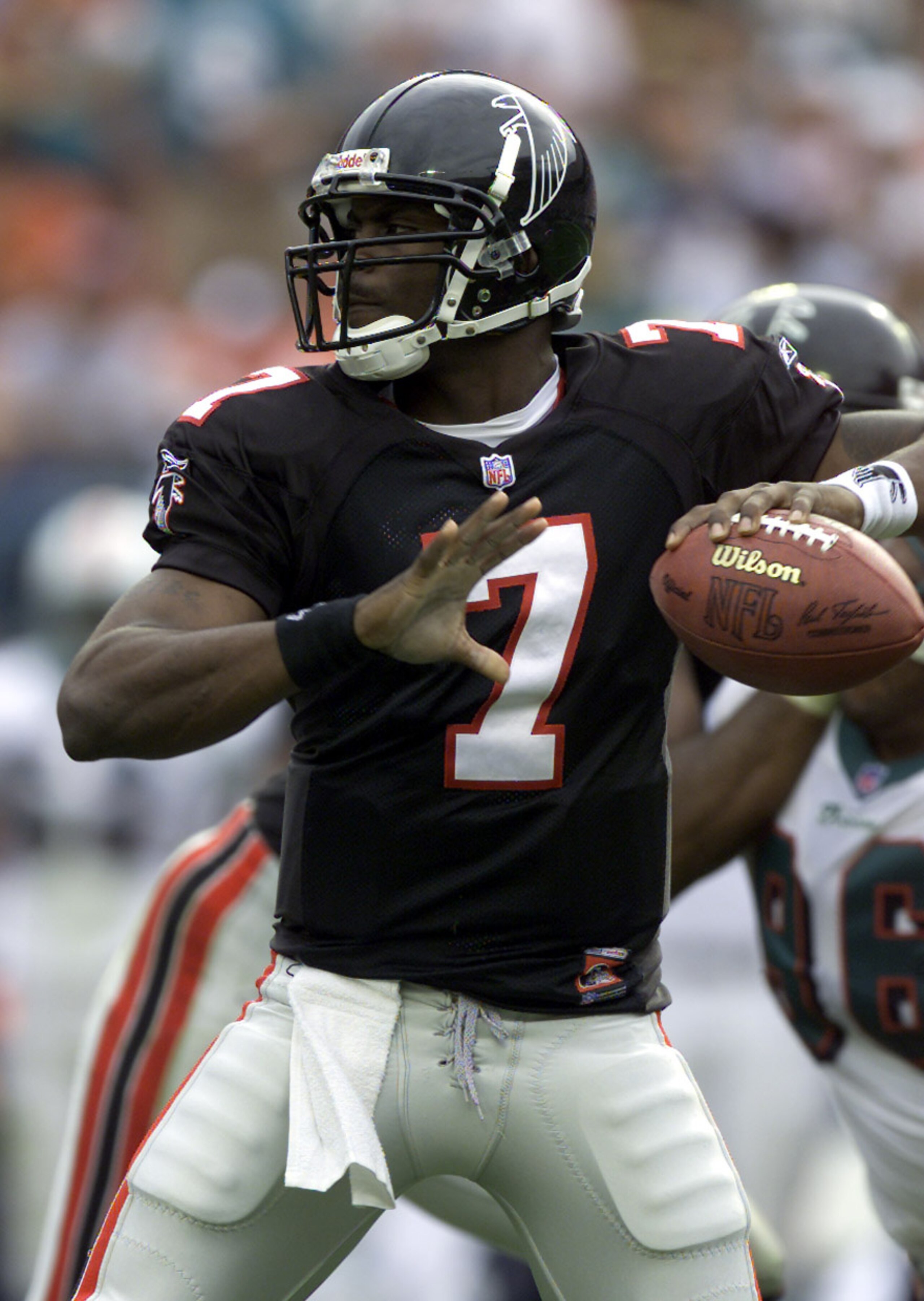 30 Dec 2001: Michael Vick # 7 of the Atlanta Falcons looks for an open man down field against the Miami Dolphins in the second quarter at Pro Player Stadium in Miami Florida. DIGITAL IMAGE. Mandatory Credit: Eliot Schechter/Getty Images