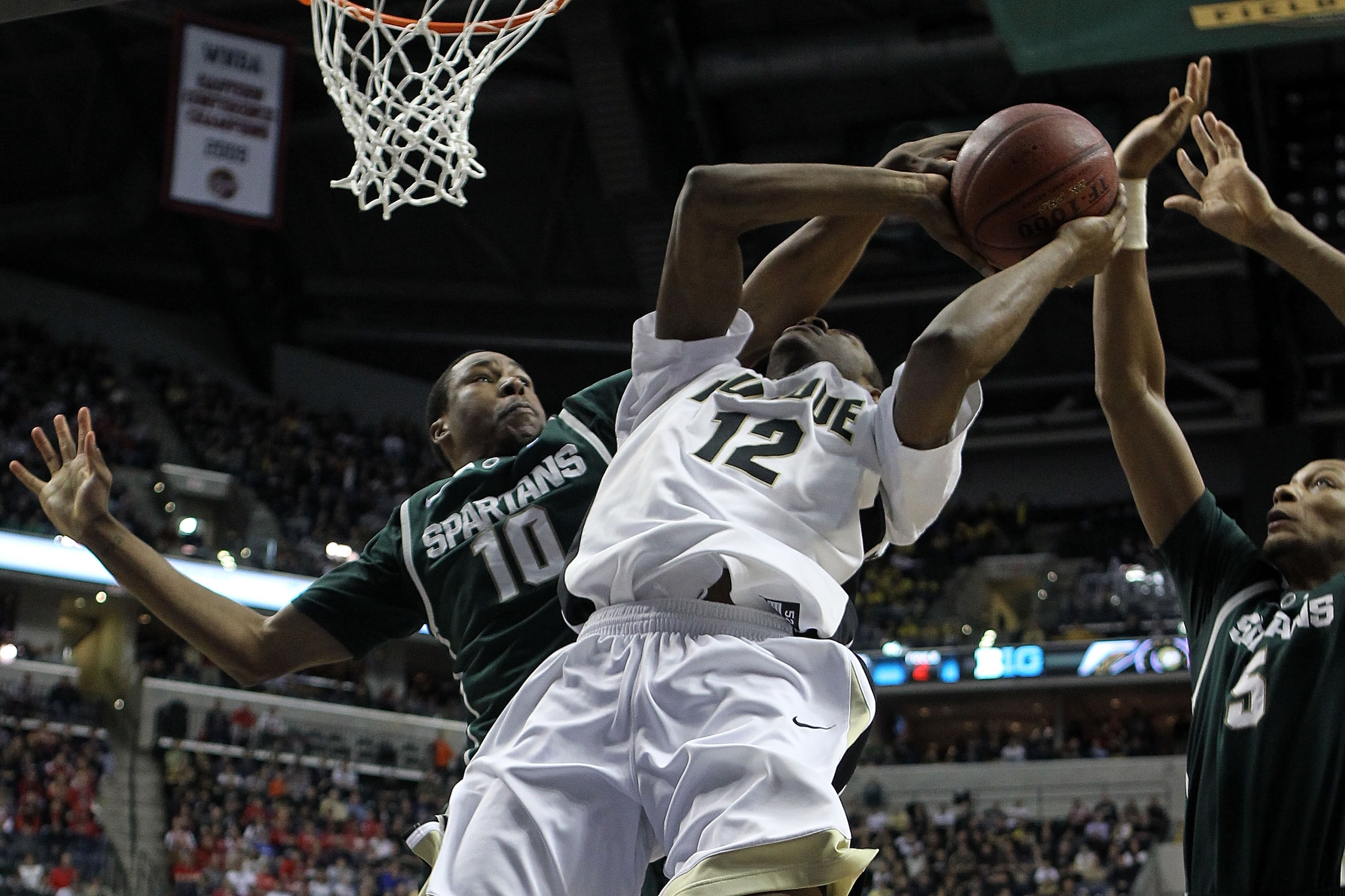 INDIANAPOLIS, IN - MARCH 11:  Delvon Roe #10 of the Michigan State Spartans defends in the first half against Kelsey Barlow #12 of the Purdue Boilermakers during the quarterfinals of the 2011 Big Ten Men's Basketball Tournament at Conseco Fieldhouse on Ma
