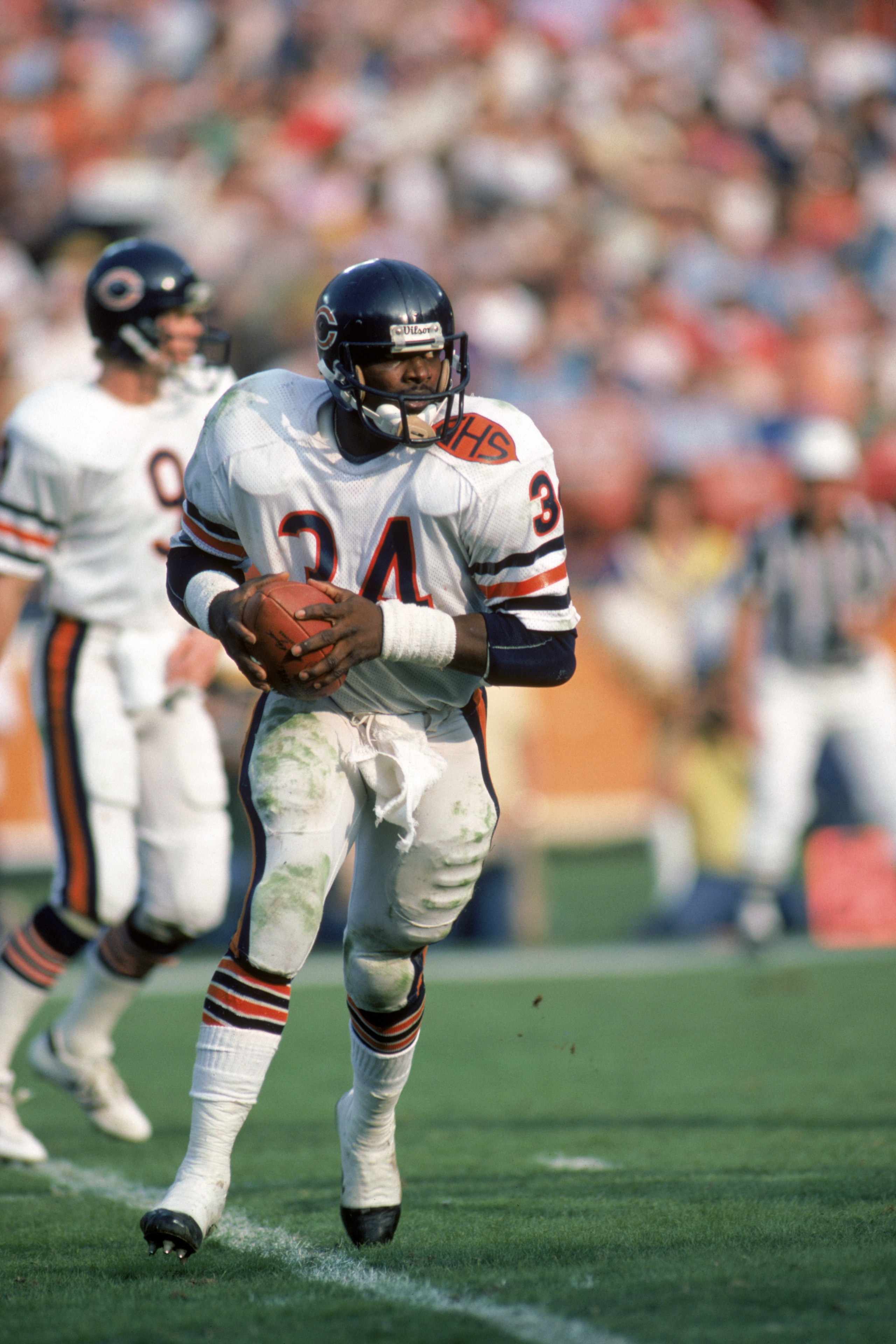 ANAHEIM, CA - NOVEMBER 6:  Running back Walter Payton #34 of the Chicago Bears runs with the ball during a game against the Los Angeles Rams at Anaheim Stadium on November 6, 1983 in Anaheim, California.   The Rams won 21-14.  (Photo by George Rose/Getty