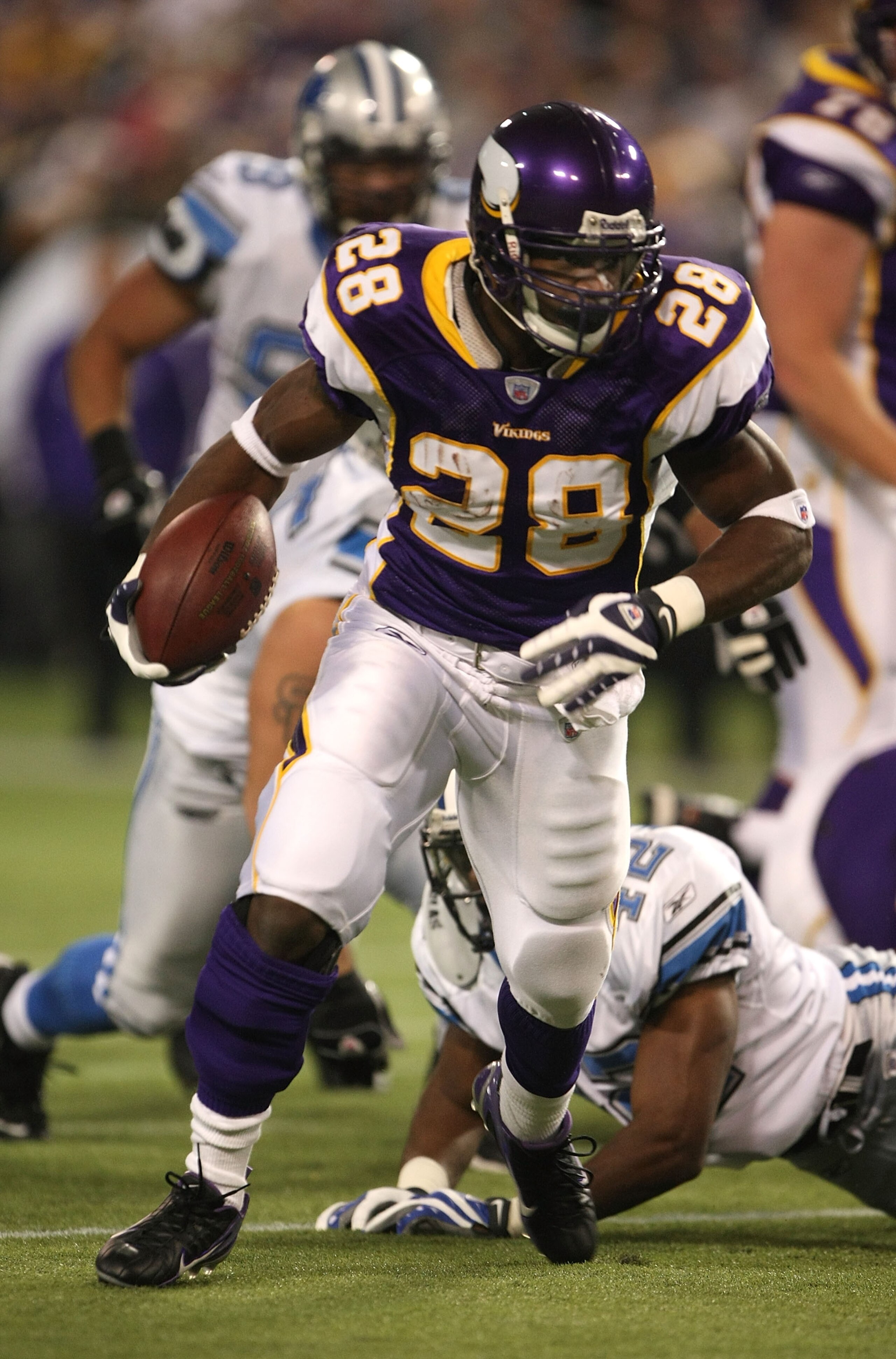MINNEAPOLIS - DECEMBER 02:  Running back Adrian Peterson #28 of the Minnesota Vikings carries the ball against the Detroit Lions defends on December 2, 2007 at the Metrodome in Minneapolis, Minnesota.  The Vikings won 42-10. (Photo by Stephen Dunn/Getty I