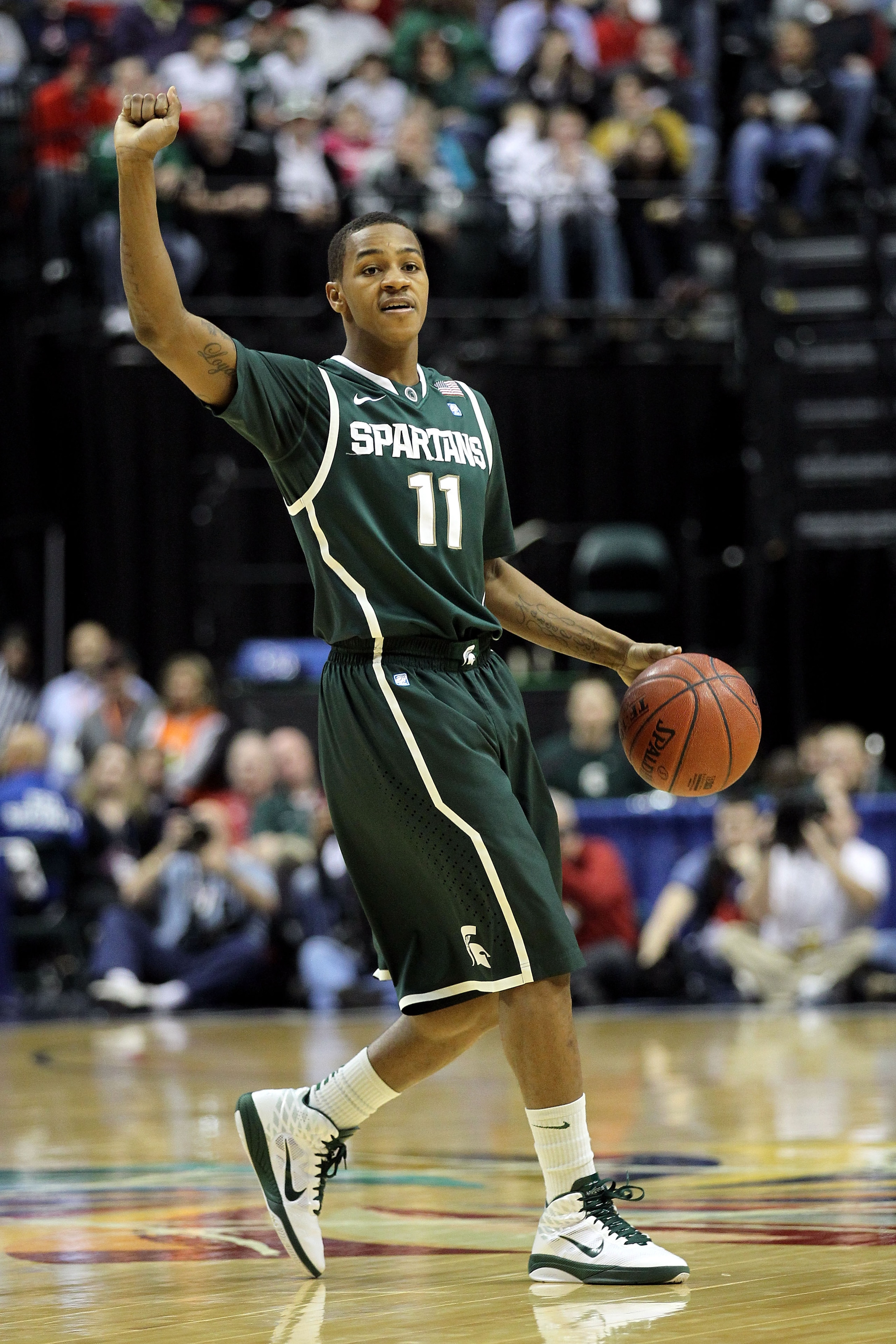 INDIANAPOLIS, IN - MARCH 12:  Keith Appling #11 of the Michigan State Spartans calls a play against the Penn State Nittany Lions during the semifinals of the 2011 Big Ten Men's Basketball Tournament at Conseco Fieldhouse on March 12, 2011 in Indianapolis,