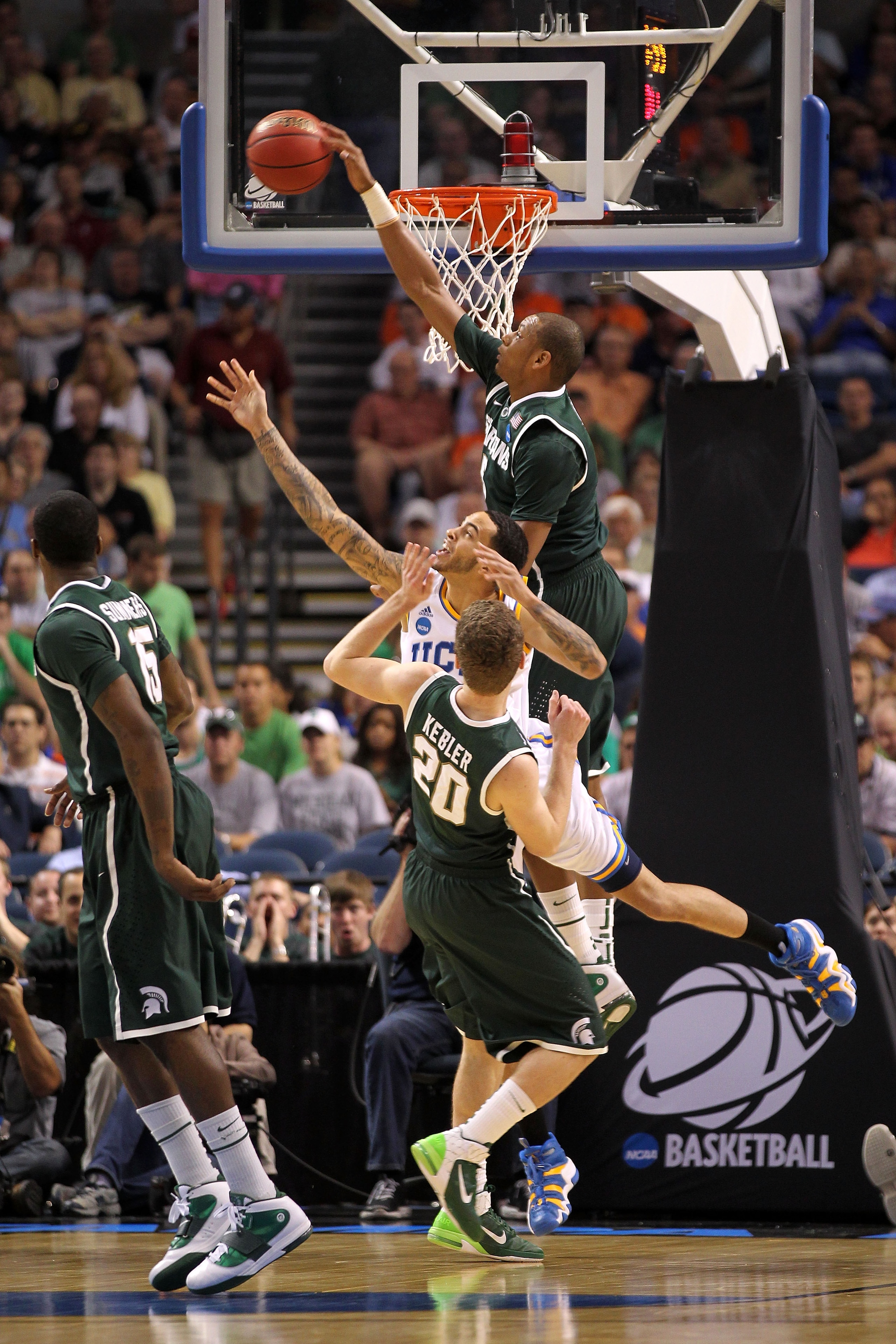 TAMPA, FL - MARCH 17:  Adreian Payne #5 of the Michigan State Spartans blocks a shot attempt in the first half by Tyler Honeycutt #23 of the UCLA Bruins during the second round of the 2011 NCAA men's basketball tournament at St. Pete Times Forum on March
