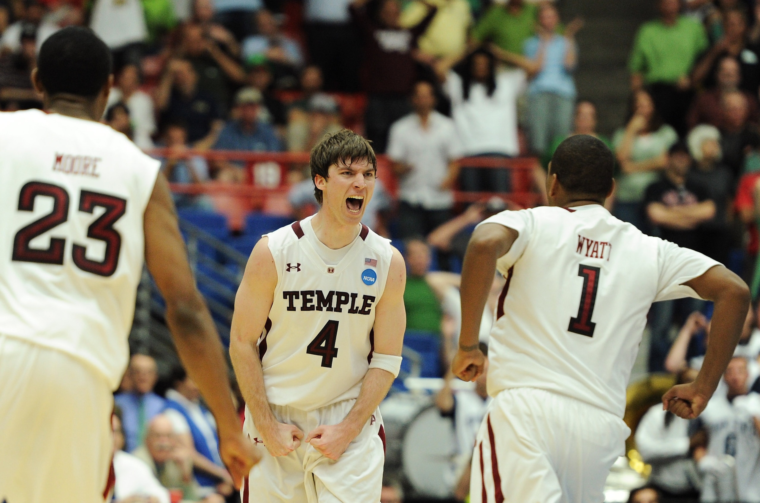 TUCSON, AZ - MARCH 17:  Juan Fernandez #4 celebrates with teammates Khalif Wyatt #1 and Ramone Moore #23 of the Temple Owls after he scored the winning basket to defeat the Penn State Nittany Lions 66 to 64 in the second round of the 2011 NCAA men's baske
