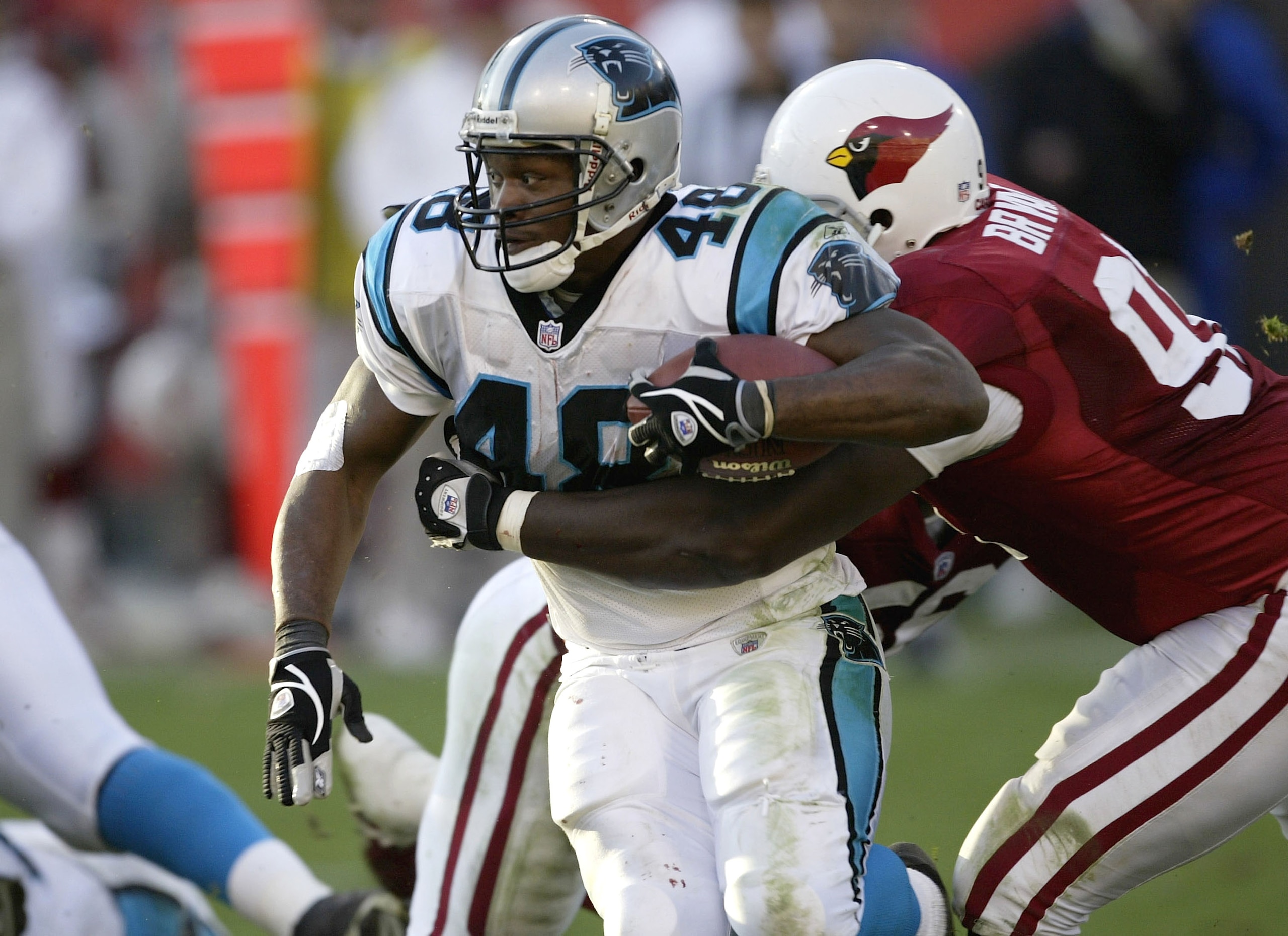 PHOENIX, AZ - DECEMBER 14:  Running back Stephen Davis #46 of the Carolina Panthers fights for yardage while being grabbed by defensive tackle Wendell Bryant # 91 of the Arizona Cardinals on December 14, 2003 at Sun Devil Stadium in Phoenix, Arizona. Caro