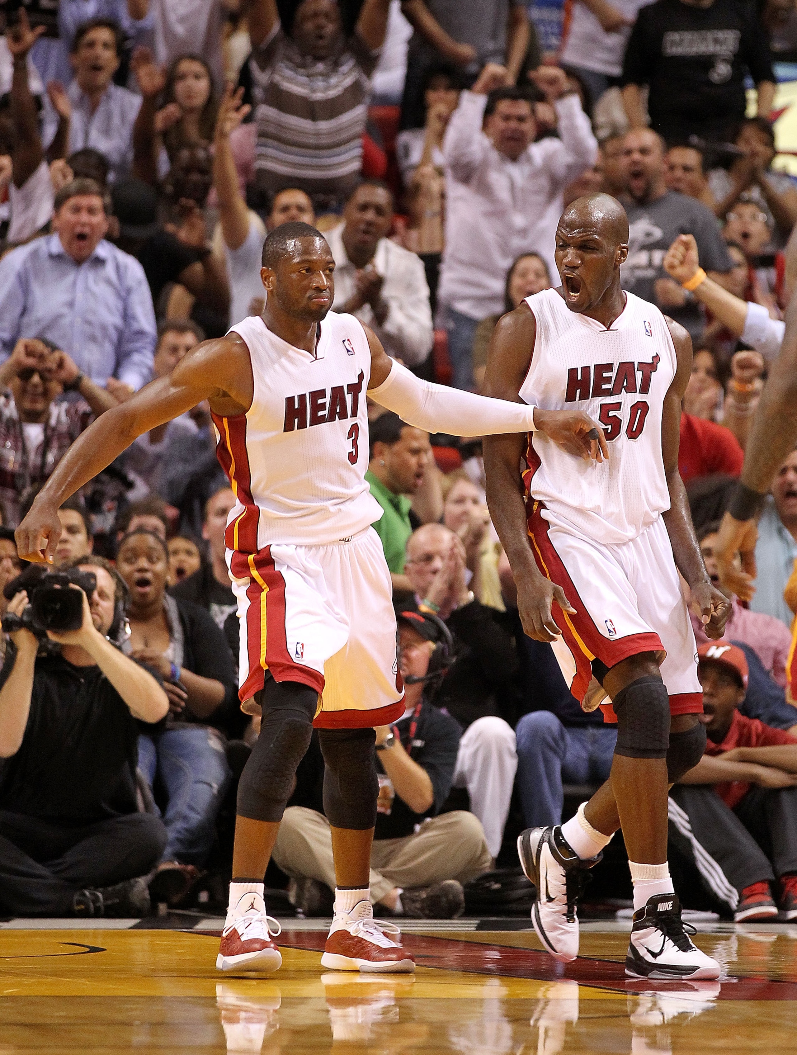 MIAMI, FL - MARCH 16: Dwyane Wade #3 and Joel Anthony #50 of the Miami Heat react after Wades dunk during a game against the Oklahoma City Thunder at American Airlines Arena on March 16, 2011 in Miami, Florida. NOTE TO USER: User expressly acknowledges an