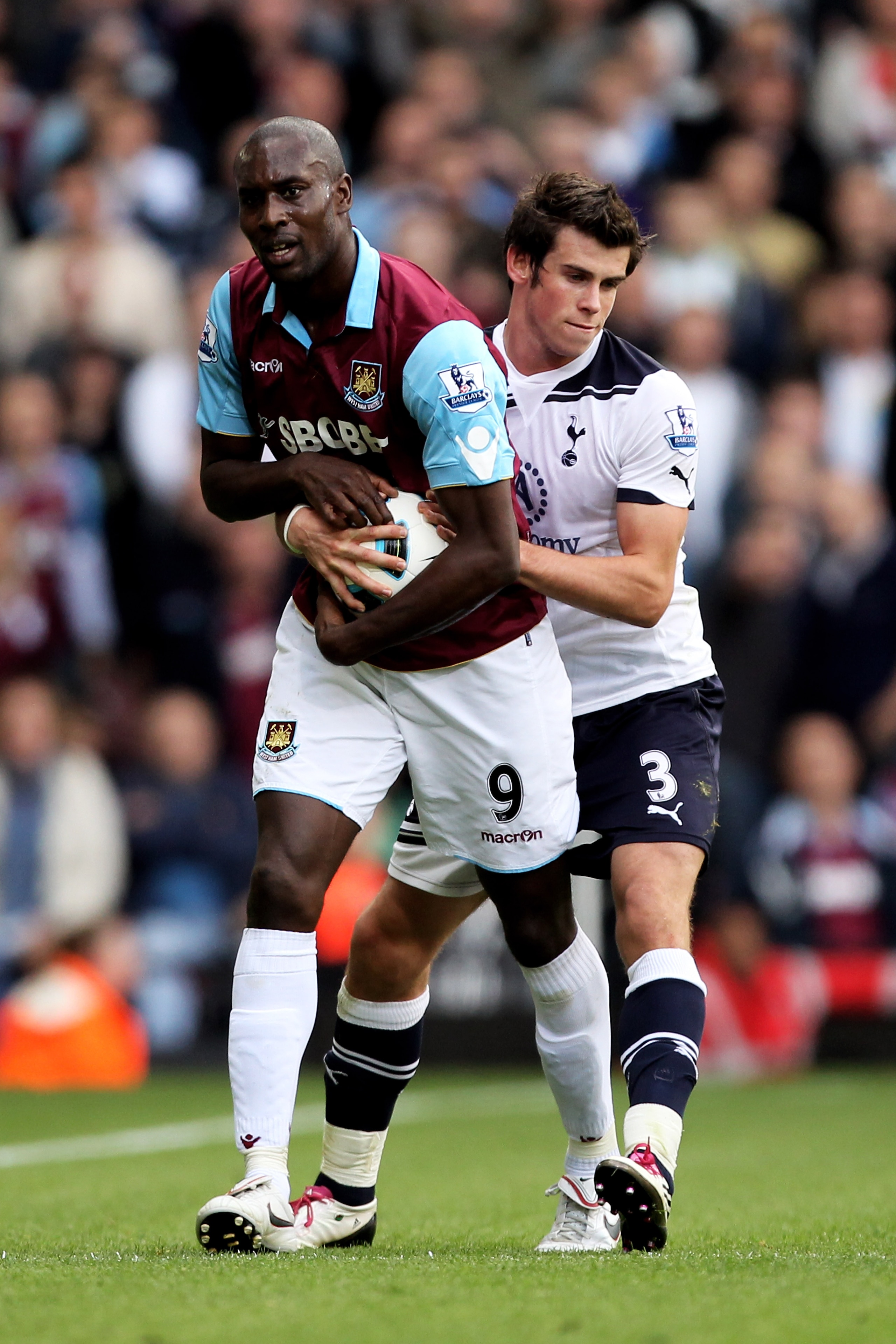LONDON, ENGLAND - SEPTEMBER 25:  Carlton Cole of West Ham refuses to give the ball to Gareth Bale of Spurs for a throw in late on during the Barclays Premier League match between West Ham United and Tottenham Hotspur at the Boleyn Ground on September 25,