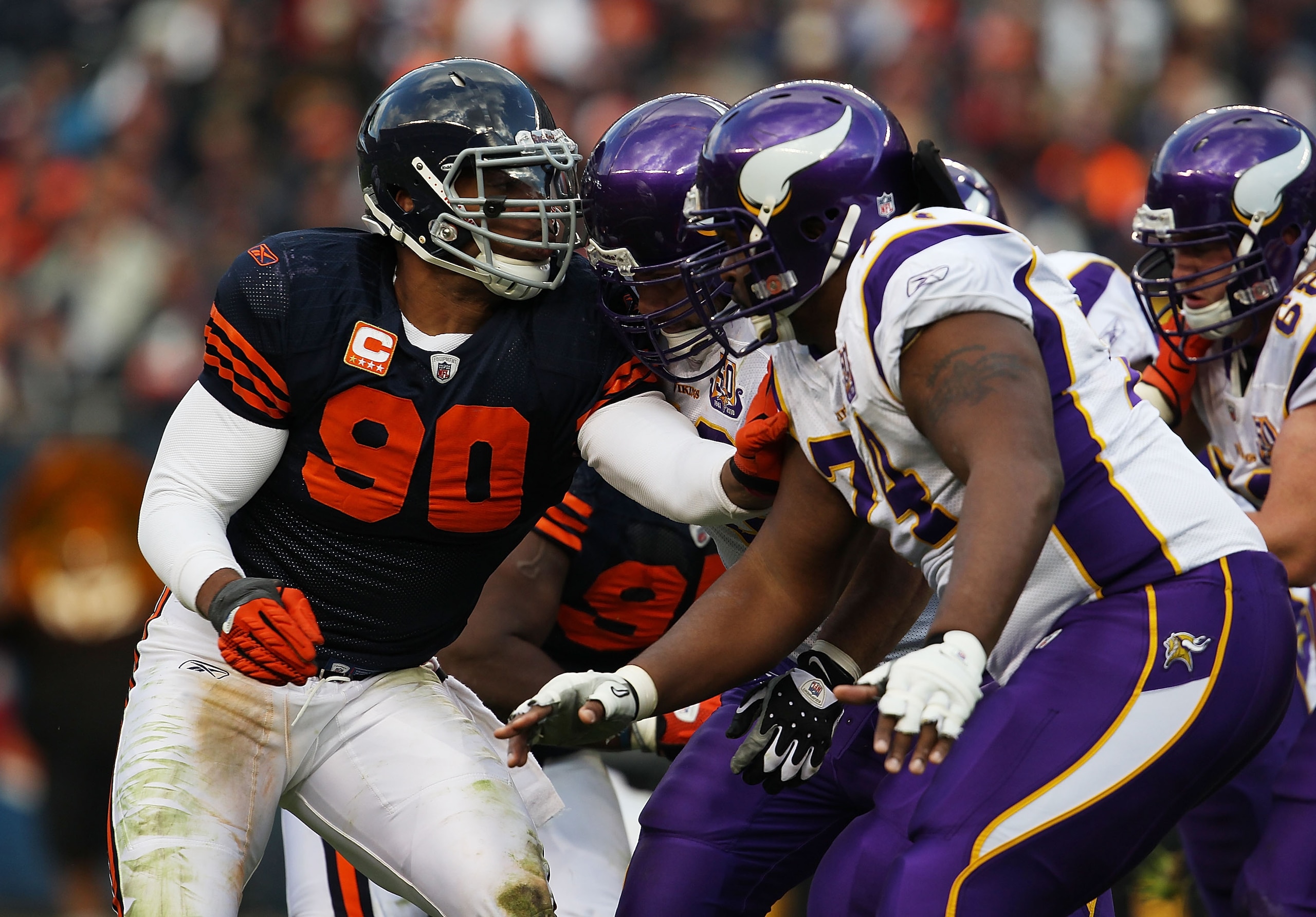 CHICAGO - NOVEMBER 14: Julius Peppers #90 of the Chicago Bears rushes against Steve Hutchinson #76 and Bryant McKinnie #74 of the Minnesota Vikings at Soldier Field on November 14, 2010 in Chicago, Illinois. The Bears defeated the Vikings 27-13. (Photo by