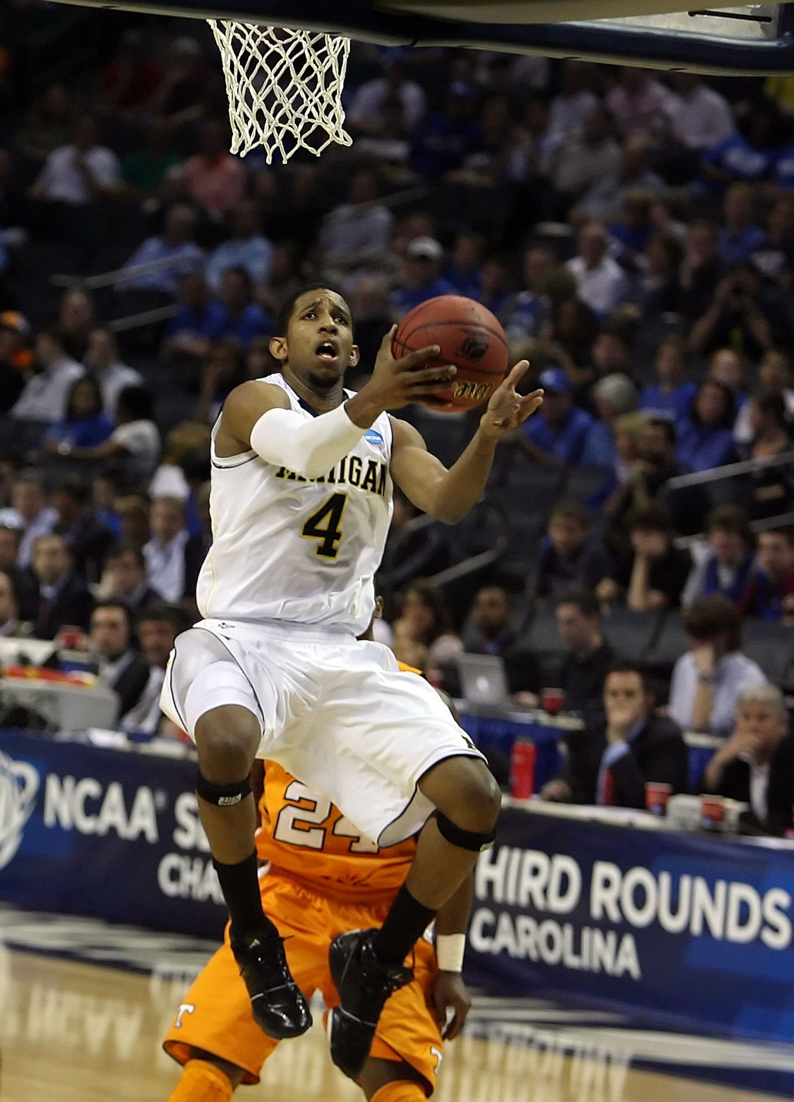 CHARLOTTE, NC - MARCH 18:  Darius Morris #4 of the Michigan Wolverines lays the ball up in the second half while taking on the Tennessee Volunteers during the second round of the 2011 NCAA men's basketball tournament at Time Warner Cable Arena on March 18