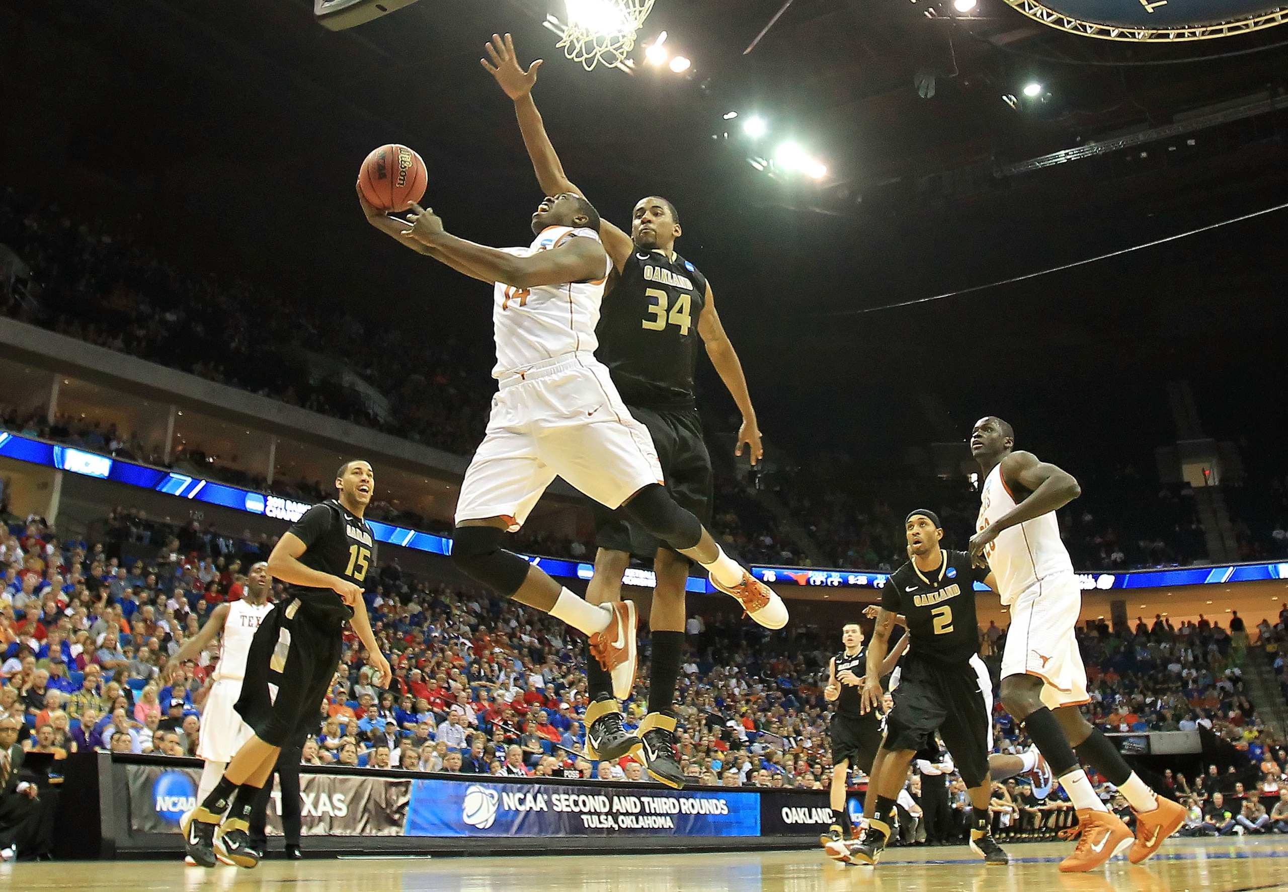 TULSA, OK - MARCH 18:  J'Covan Brown #14 of the Texas Longhorns goes up for a shot against Keith Benson #34 of the Oakland Golden Grizzlies during the second round of the 2011 NCAA men's basketball tournament at BOK Center on March 18, 2011 in Tulsa, Okla