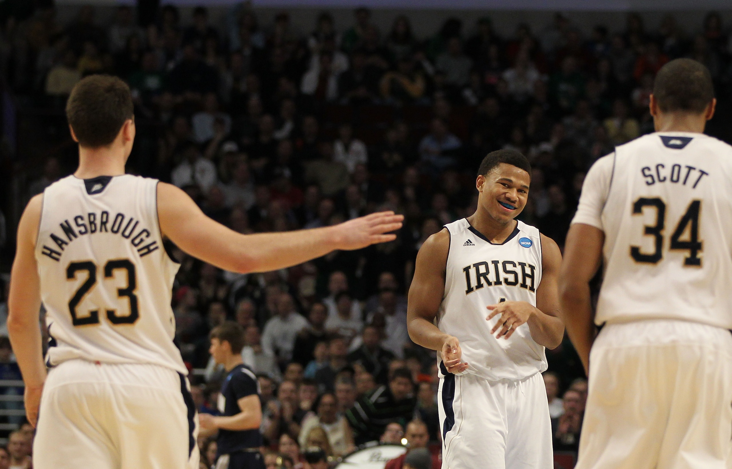 CHICAGO, IL - MARCH 18:  Ben Hansbrough, Tyrone Nash #1 and Carleton Scott #34 of the Notre Dame Fighting Irish celebrate their 69-56 win over the Akron Zips during the second round of the 2011 NCAA men's basketball tournament at the United Center on Marc