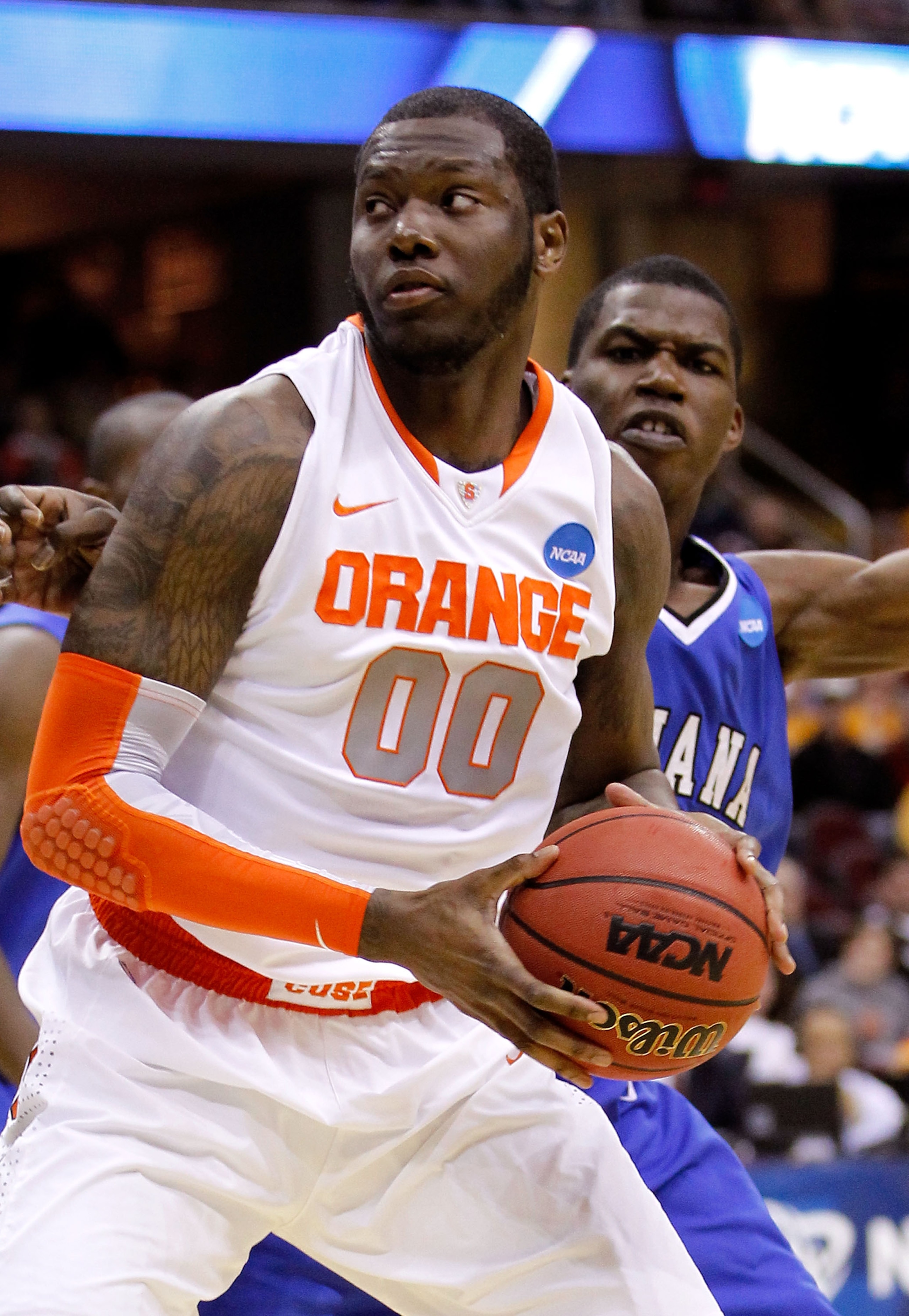CLEVELAND, OH - MARCH 18: Rick Jackson #00 of the Syracuse Orange handles the ball against Myles Walker #34 of the Indiana State Sycamores during the second round of the 2011 NCAA men's basketball tournament at Quicken Loans Arena on March 18, 2011 in Cle
