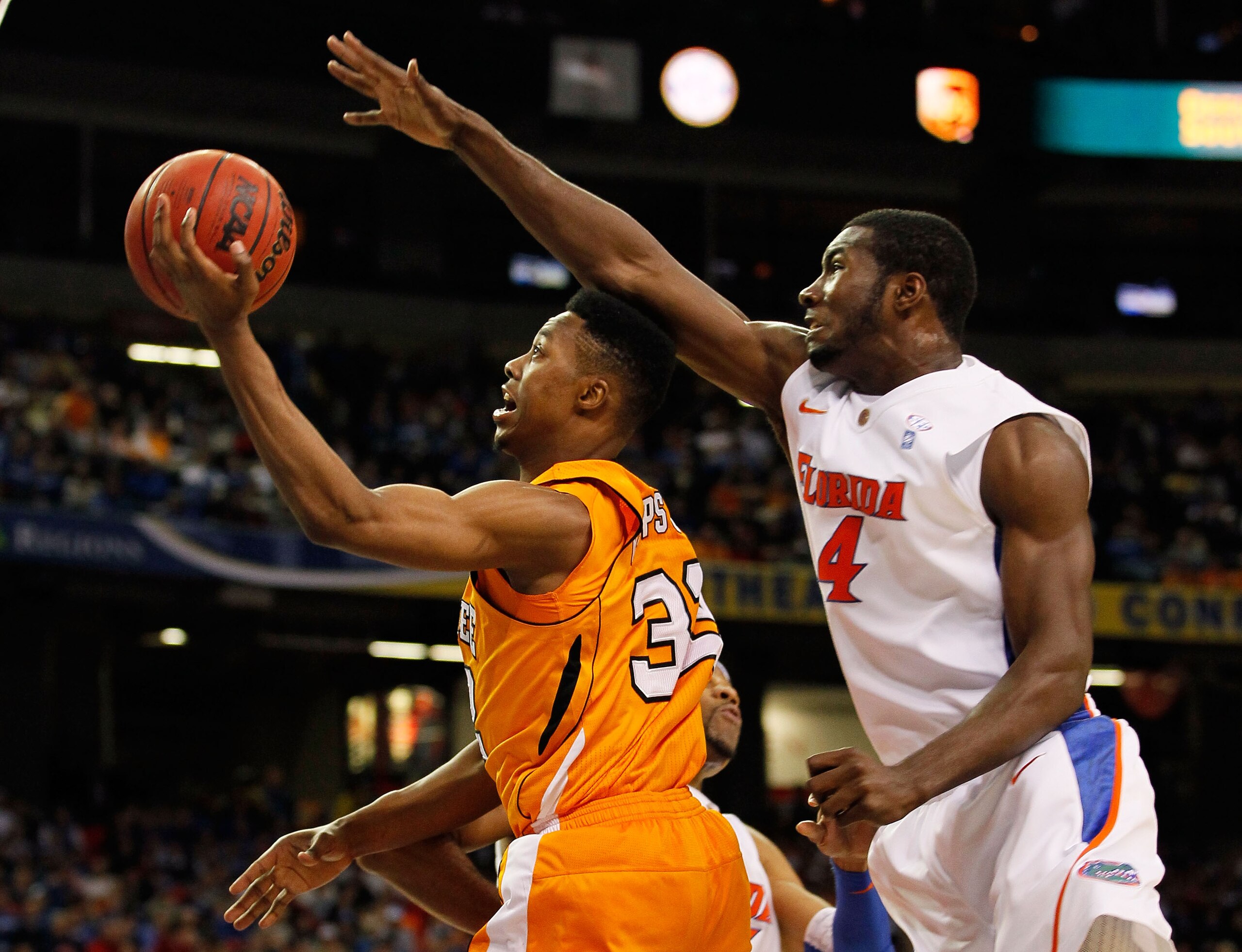 ATLANTA, GA - MARCH 11:  Scotty Hopson #32 of the Tennessee Volunteers goes up for a shot in front of Patric Young #4 of the Florida Gators during the quarterfinals of the SEC Men's Basketball Tournament at Georgia Dome on March 11, 2011 in Atlanta, Georg