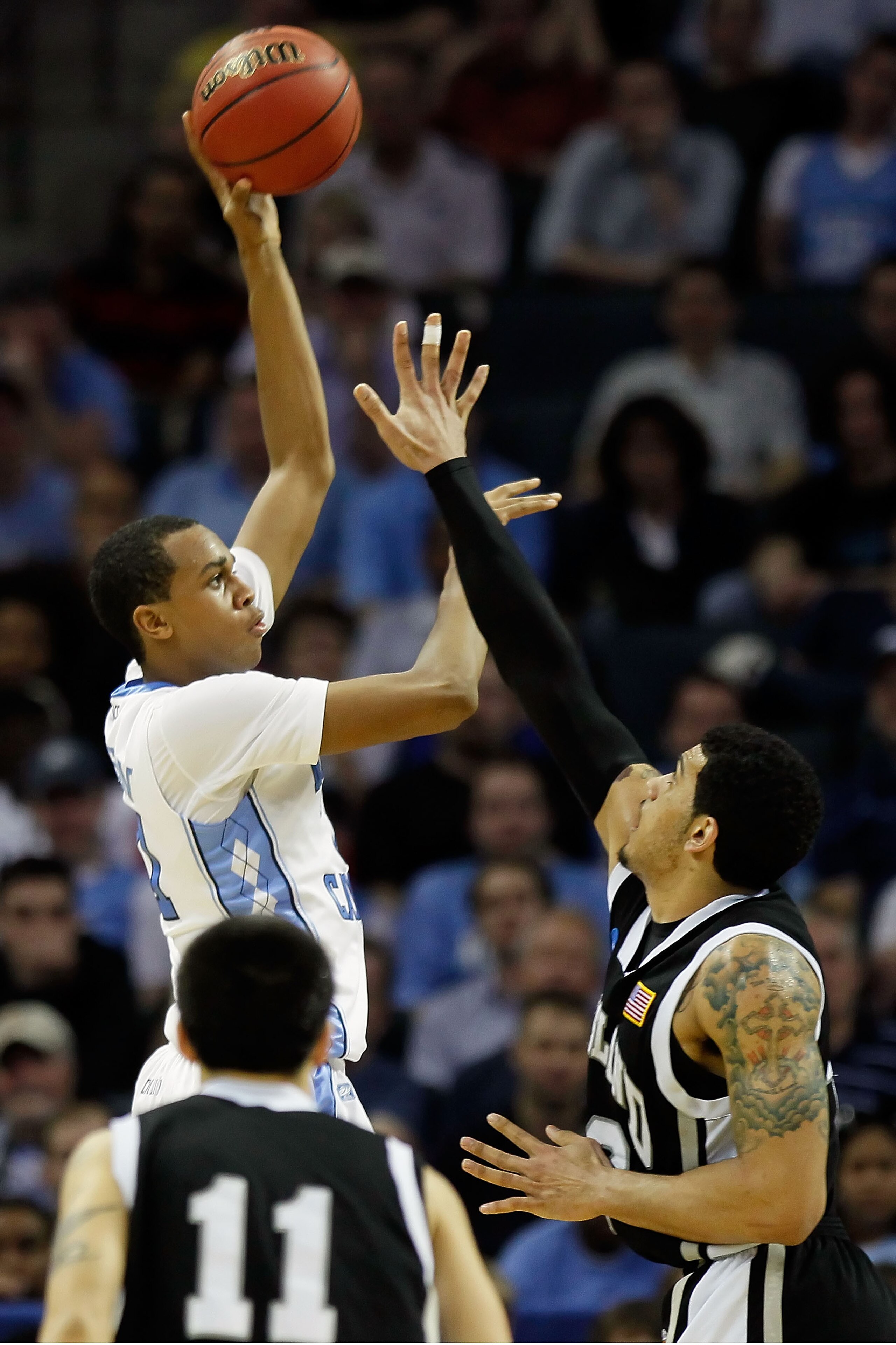 CHARLOTTE, NC - MARCH 18:  John Henson #31 of the North Carolina Tar Heels shoots over Julian Boyd #42 of the Long Island Blackbirds during the second round of the 2011 NCAA men's basketball tournament at Time Warner Cable Arena on March 18, 2011 in Charl