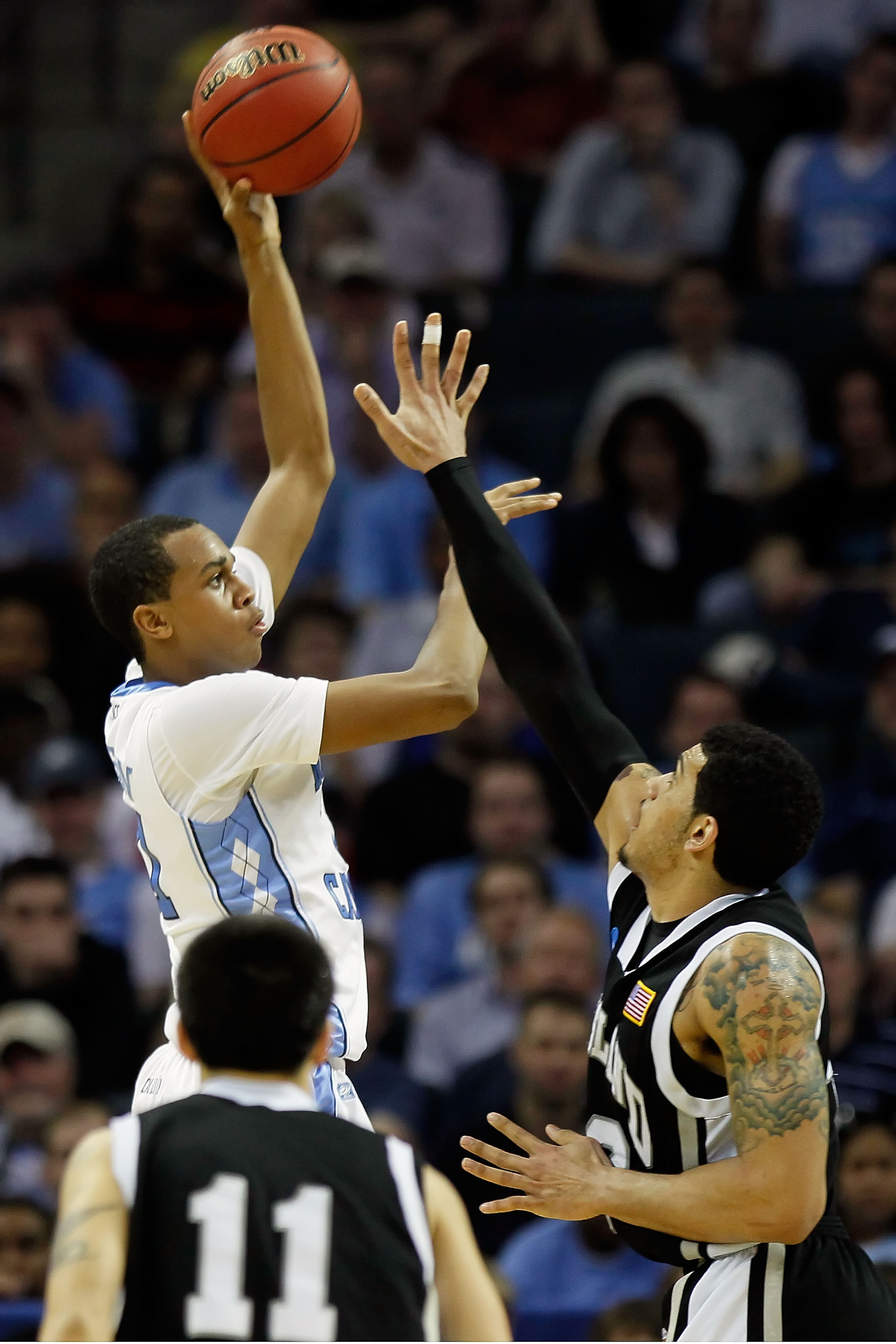 CHARLOTTE, NC - MARCH 18:  John Henson #31 of the North Carolina Tar Heels shoots over Julian Boyd #42 of the Long Island Blackbirds during the second round of the 2011 NCAA men's basketball tournament at Time Warner Cable Arena on March 18, 2011 in Charl