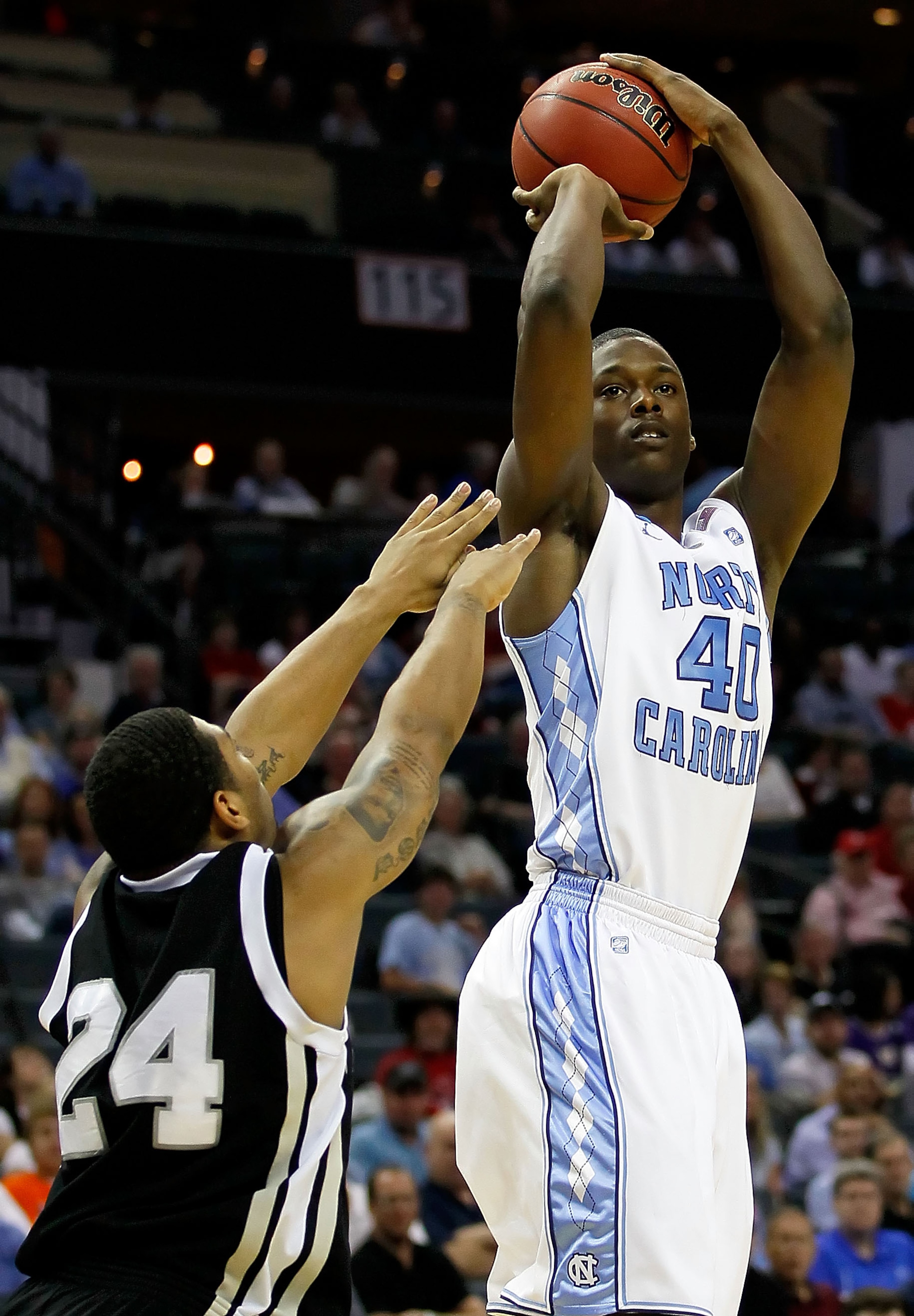 CHARLOTTE, NC - MARCH 18:  Harrison Barnes #40 of the North Carolina Tar Heels shoots over David Hicks #24 of the Long Island Blackbirds in the first half during the second round of the 2011 NCAA men's basketball tournament at Time Warner Cable Arena on M