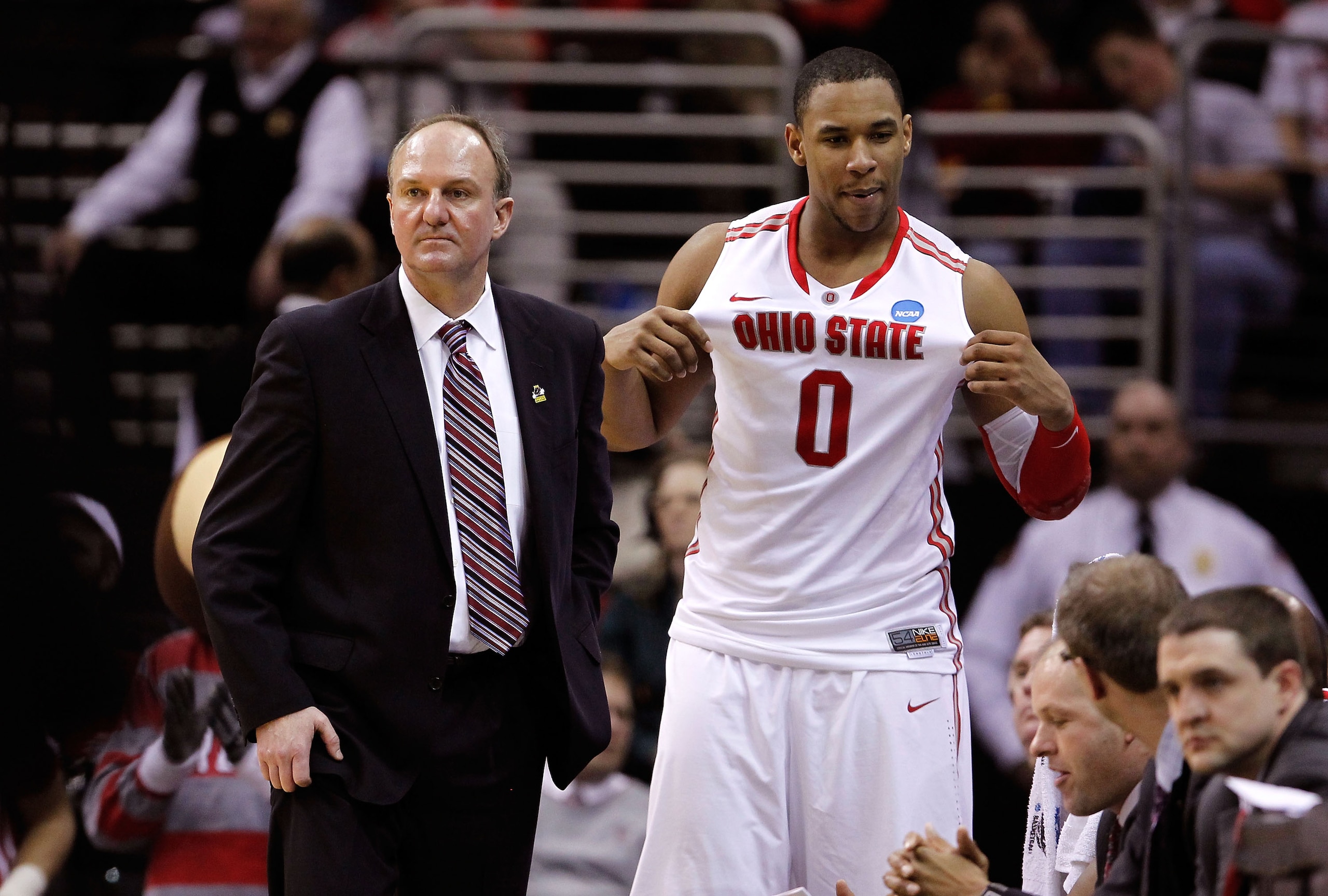 CLEVELAND, OH - MARCH 18: Jared Sullinger #0 of the Ohio State Buckeyes holds his jersey out as head coach Thad Matta looks on late in the game against the Texas-San Antonio Roadrunners during the second round of the 2011 NCAA men's basketball tournament