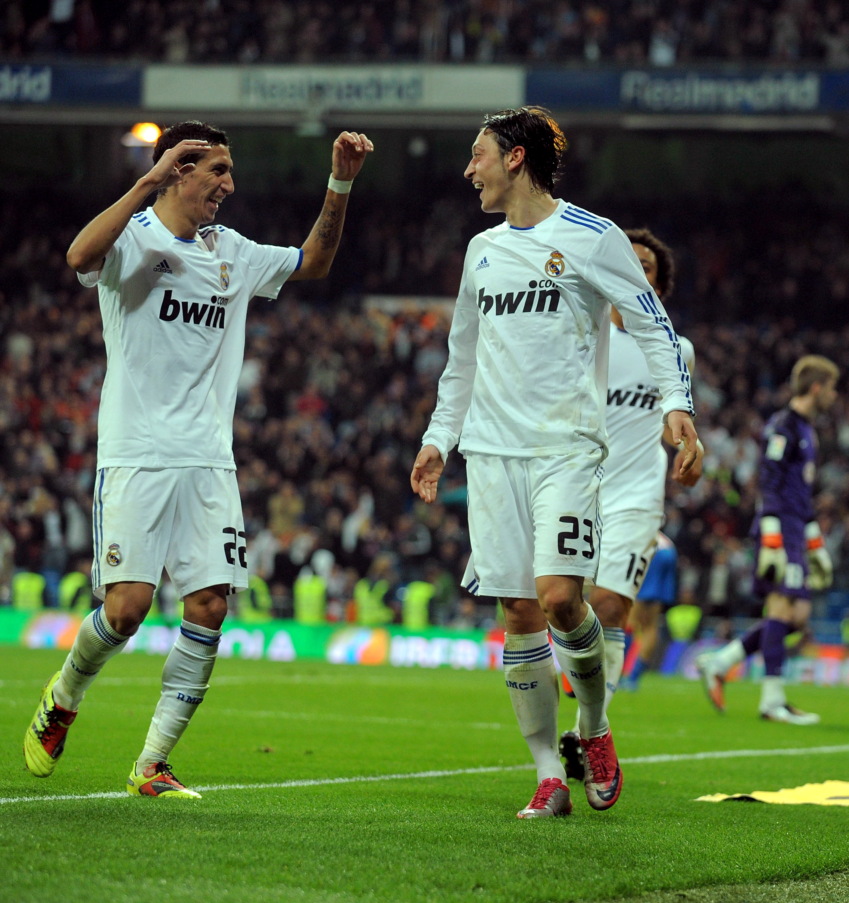 MADRID, SPAIN - JANUARY 13:  Mesut Ozil (R)of Real Madrid celebrates with Angel di Maria after scoring Real's third goal during the Copa del Rey quarter final first leg match between Real Madrid and Atletico Madrid at Estadio Santiago Bernabeu on January