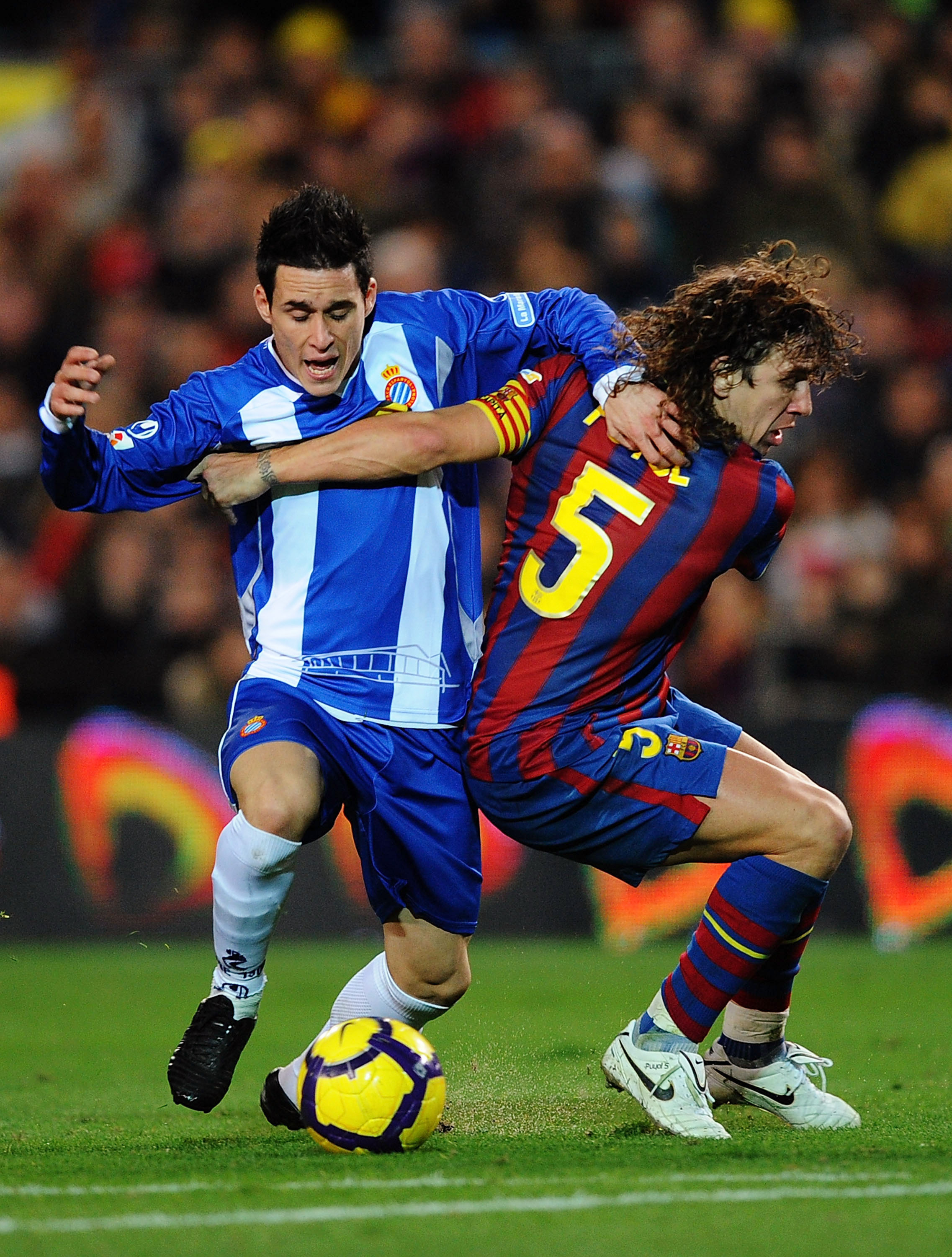 BARCELONA, SPAIN - DECEMBER 12: Carles Puyol (R) of Barcelona holds back Jose Callejon of Espanyol   during the La Liga match between Barcelona and  Espanyol at the Camp Nou stadium Stadium on December 12, 2009 in Madrid, Spain.  (Photo by Denis Doyle/Get