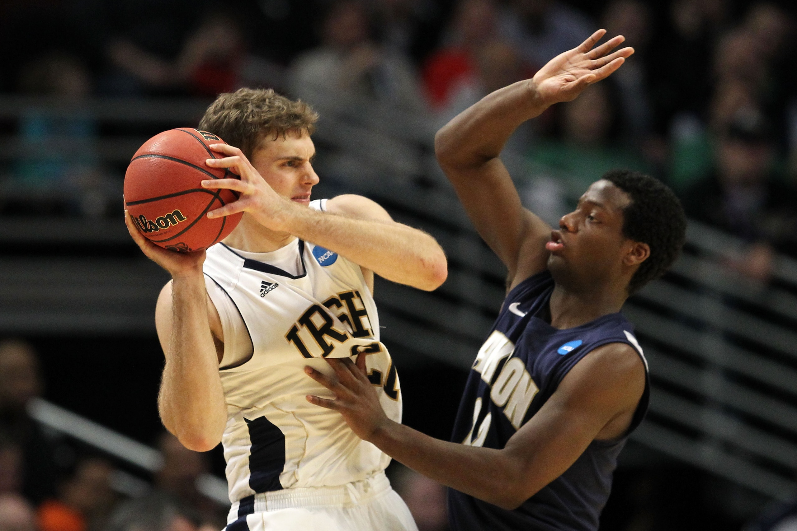 CHICAGO, IL - MARCH 18:  Tim Abromaitis #21 of the Notre Dame Fighting Irish looks to pass against Quincy Diggs #22 of the Akron Zips in the second half during the second round of the 2011 NCAA men's basketball tournament at the United Center on March 18,