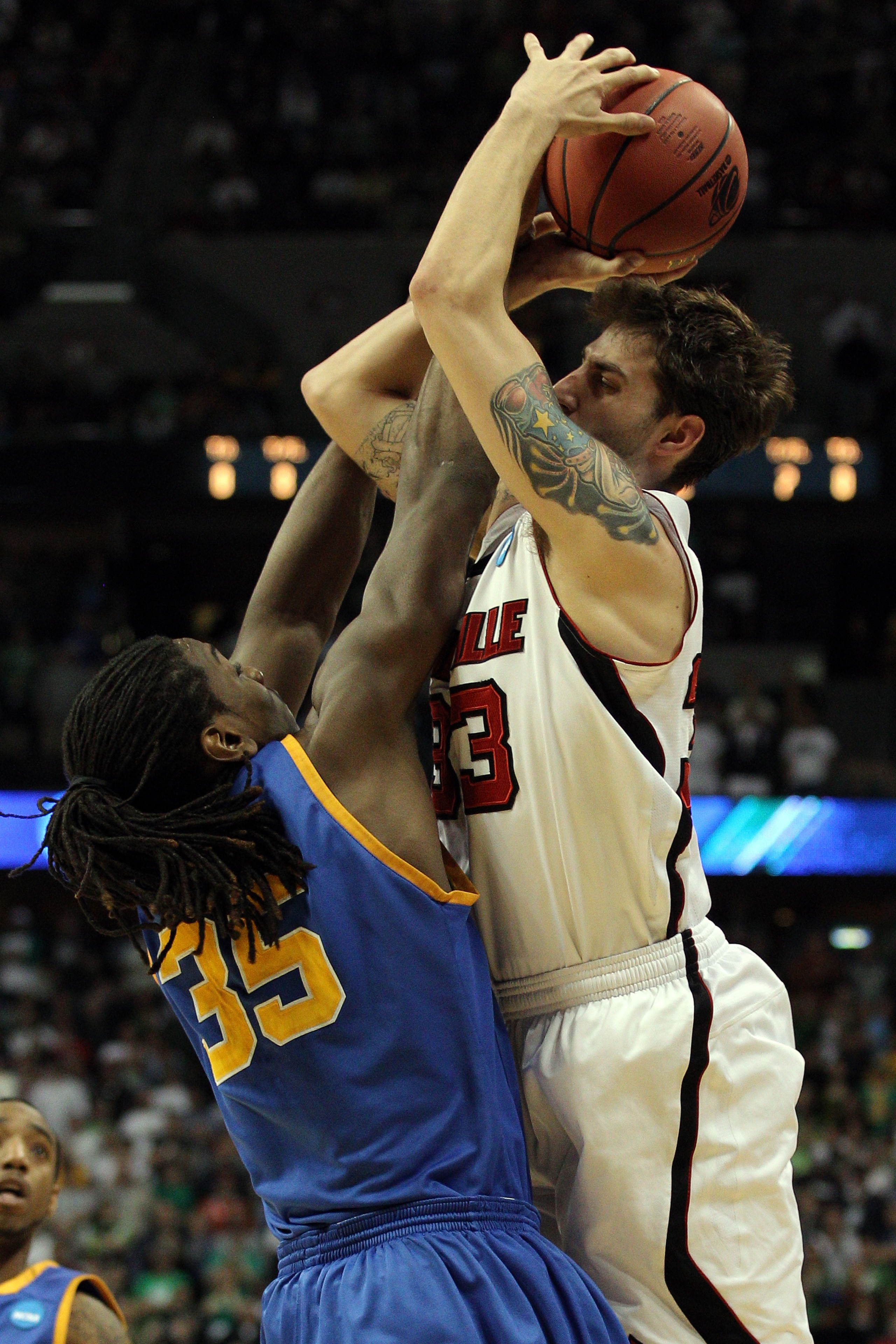 DENVER, CO - MARCH 17:  Kenneth Faried #35 of the Morehead State Eagles blocks the shot of Mike Marra #33 of the Louisville Cardinals with time running out in the second half during the second round of the 2011 NCAA men's basketball tournament at Pepsi Ce
