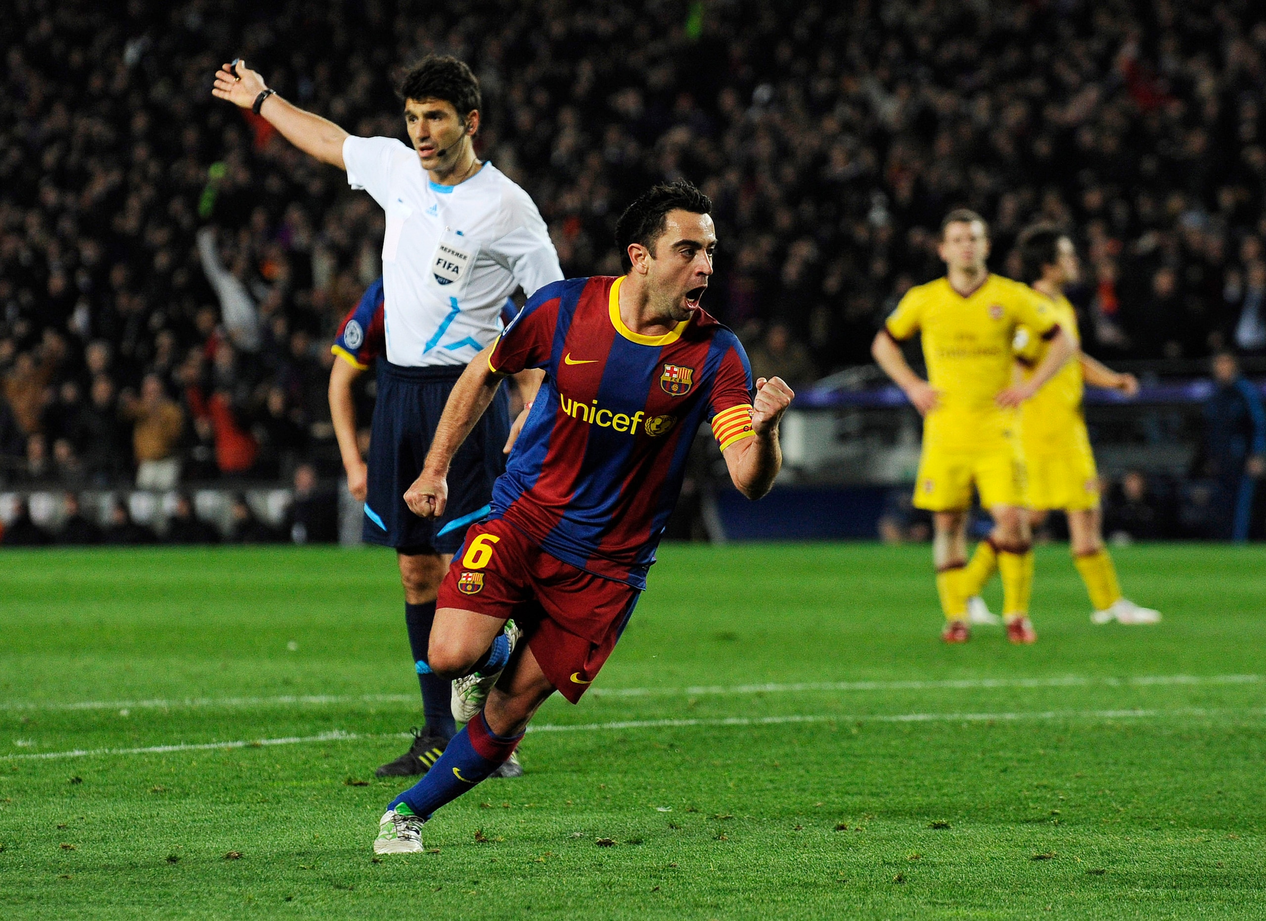 BARCELONA, SPAIN - MARCH 08:  Xavi Hernandez of FC Barcelona (C) celebrates after scoring his team's second goal during the UEFA Champions League round of 16 second leg match between Barcelona and Arsenal at the Camp Nou stadium on March 8, 2011 in Barcel
