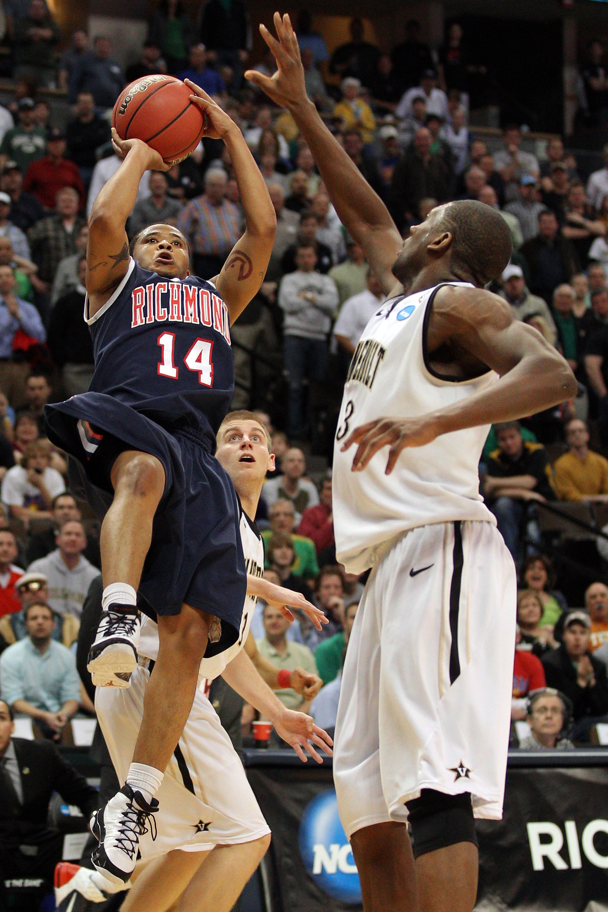 DENVER, CO - MARCH 17:  Kevin Anderson #14 of the Richmond Spiders goes up for a shot late in the second half against Festus Ezeli #3 of the Vanderbilt Commodores during the second round of the 2011 NCAA men's basketball tournament at Pepsi Center on Marc